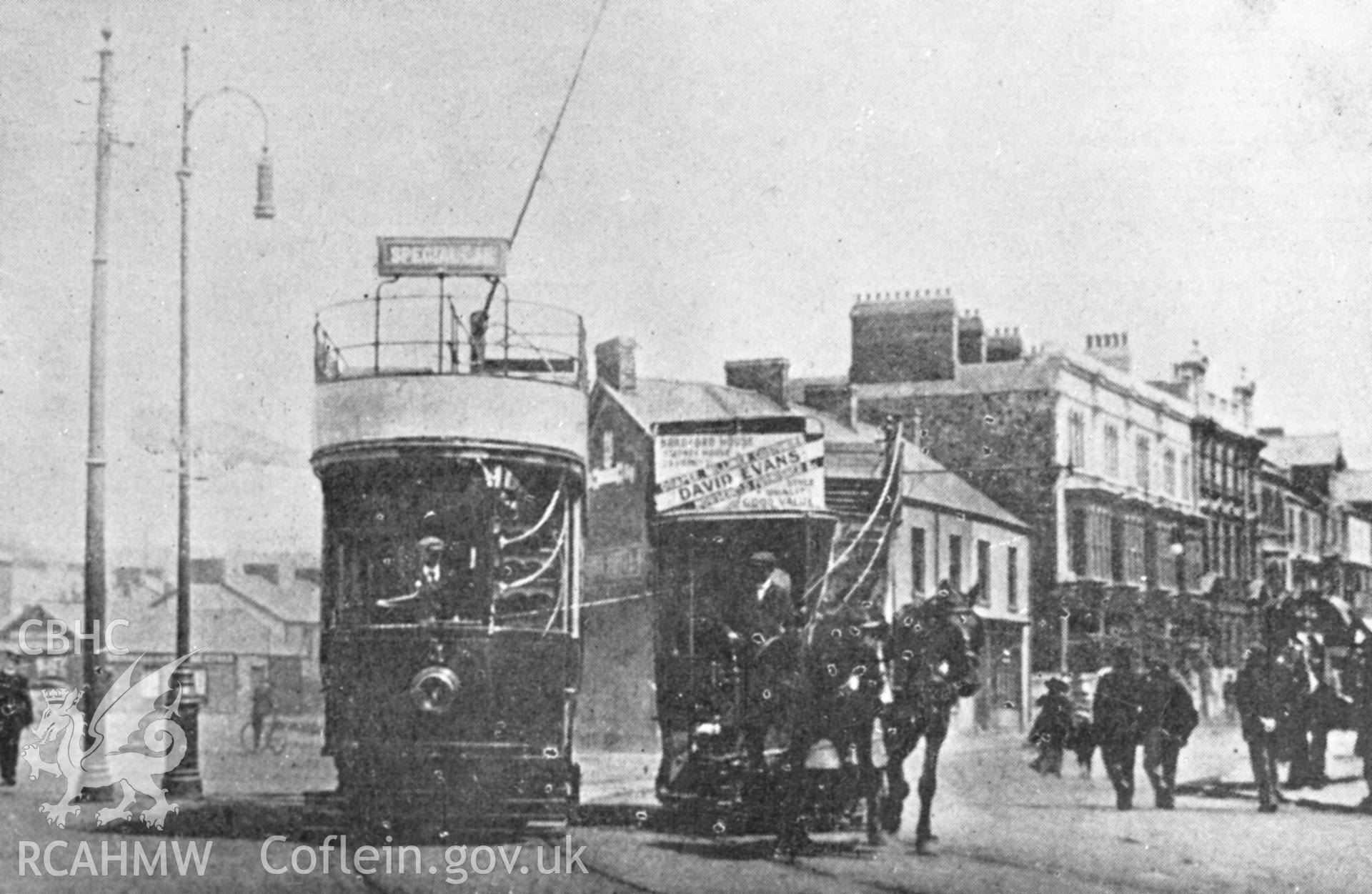 Black and white acetate negative showing electric tram and horse-drawn tram in Llanelli.