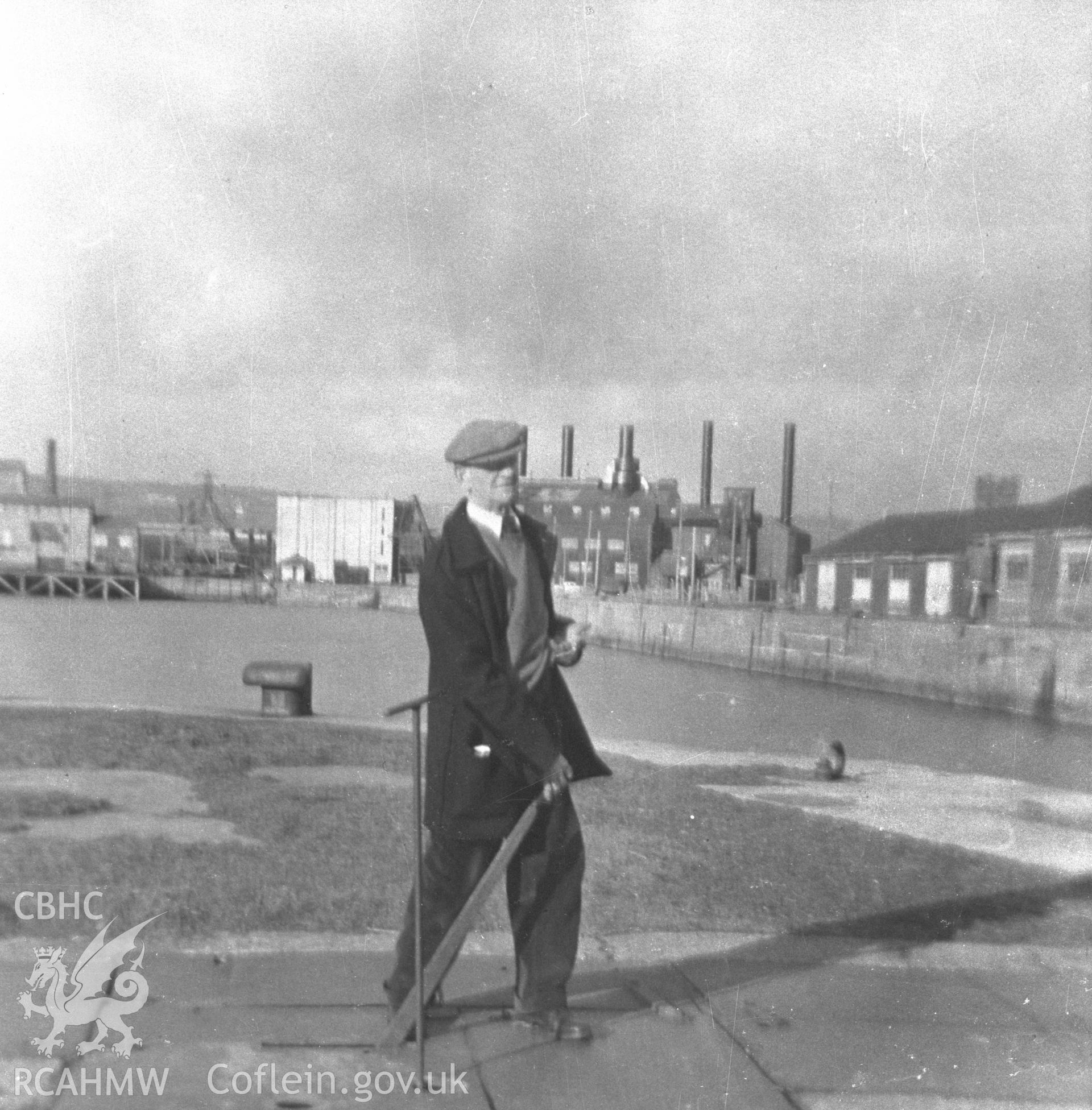 Black and white acetate negative showing Llanelli Power Station with figure in foreground.