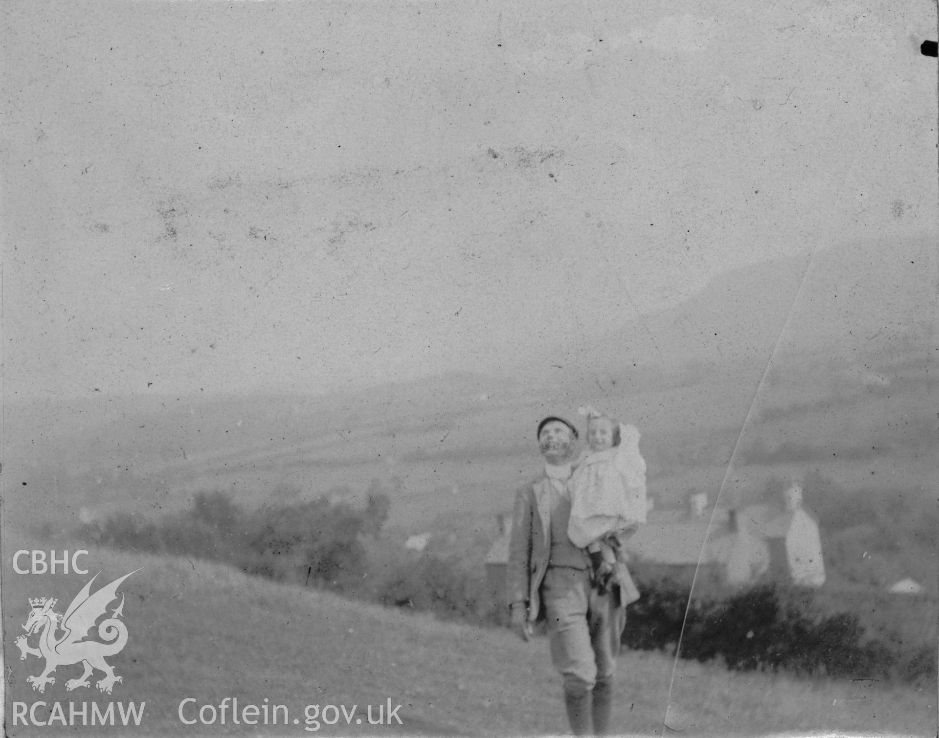 "Pontardulais 1903". Photo showing an adult carrying a child, digitised from a photograph album showing views of Aberystwyth and District, produced by David John Saer, school teacher of Aberystwyth. Loaned for copying by Dr Alan Chamberlain.