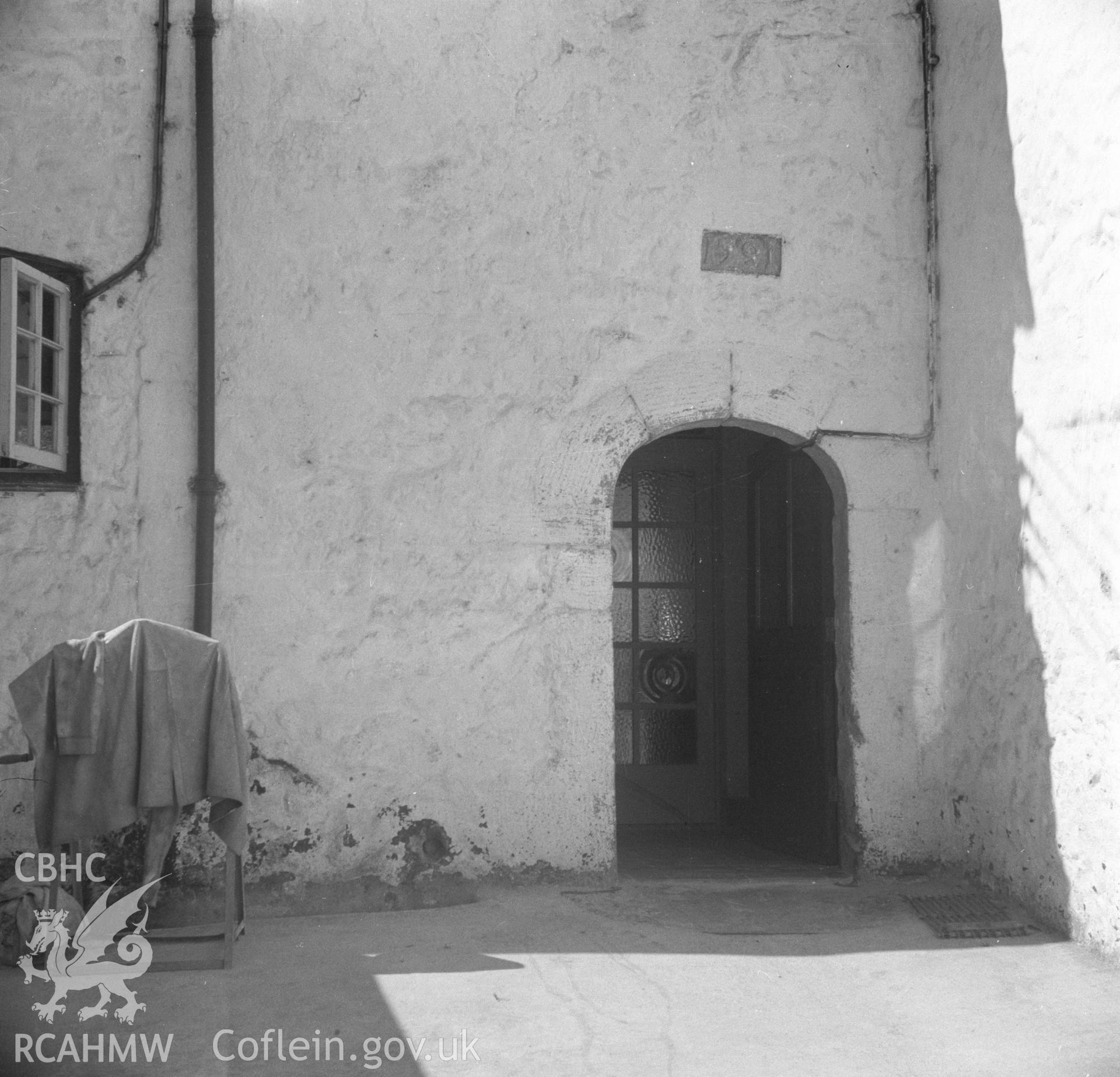 Black and white acetate negative showing exterior detail of doorway with datestone at Hendre-Uchaf, Abergele.
