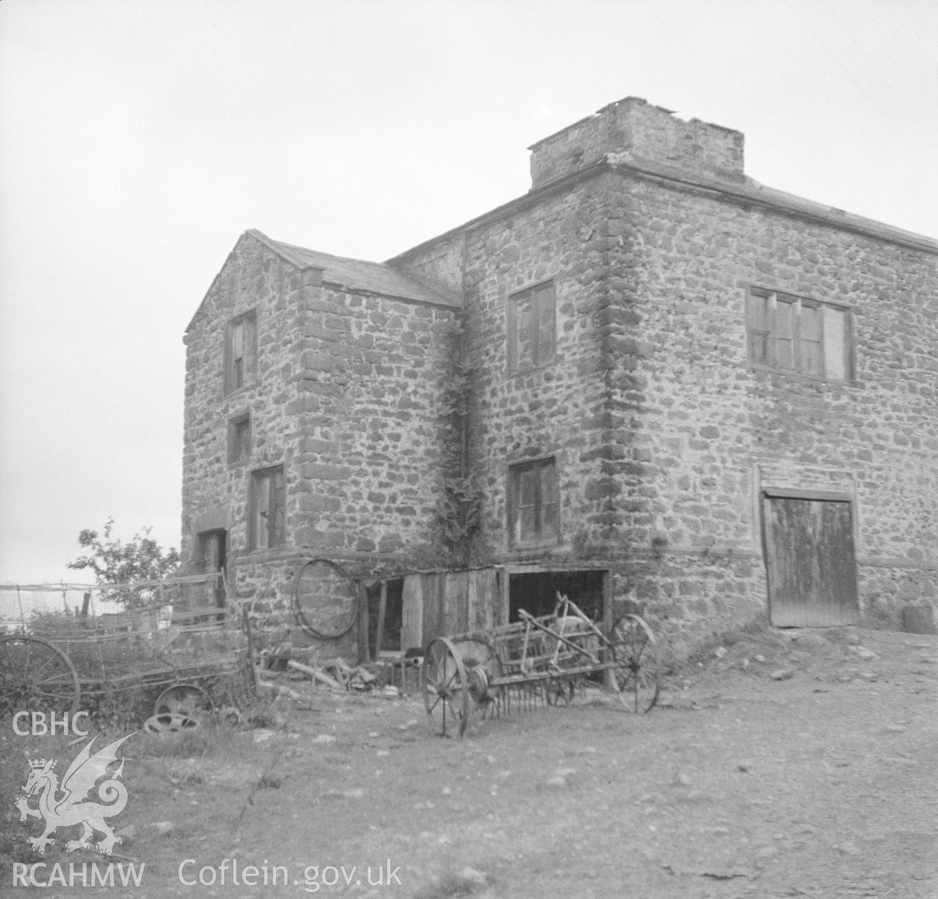 Black and white acetate negative showing exterior view with farm machinery in foreground, Trimley Hall, Llanfynydd.