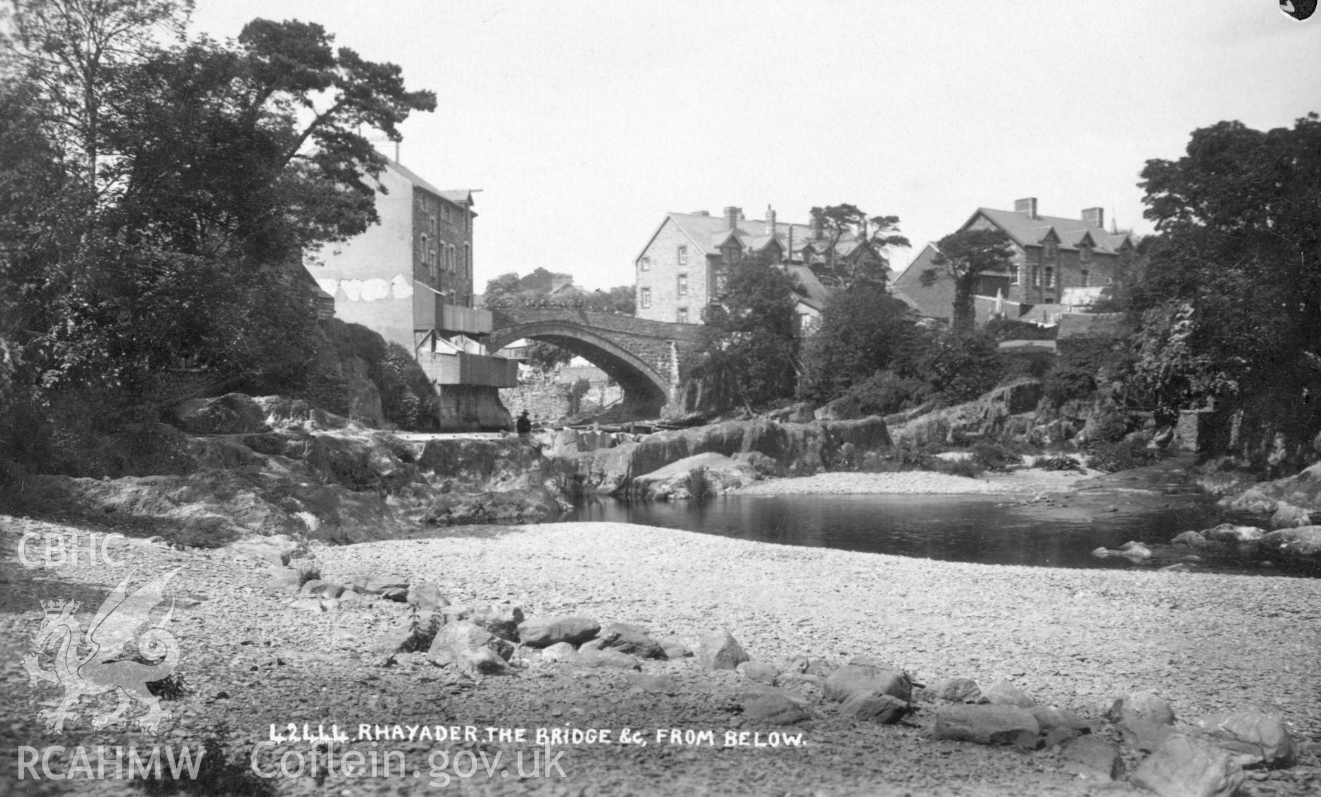 Original postcard showing Rhayader Bridge and nearby buildings - image taken from the river bank.