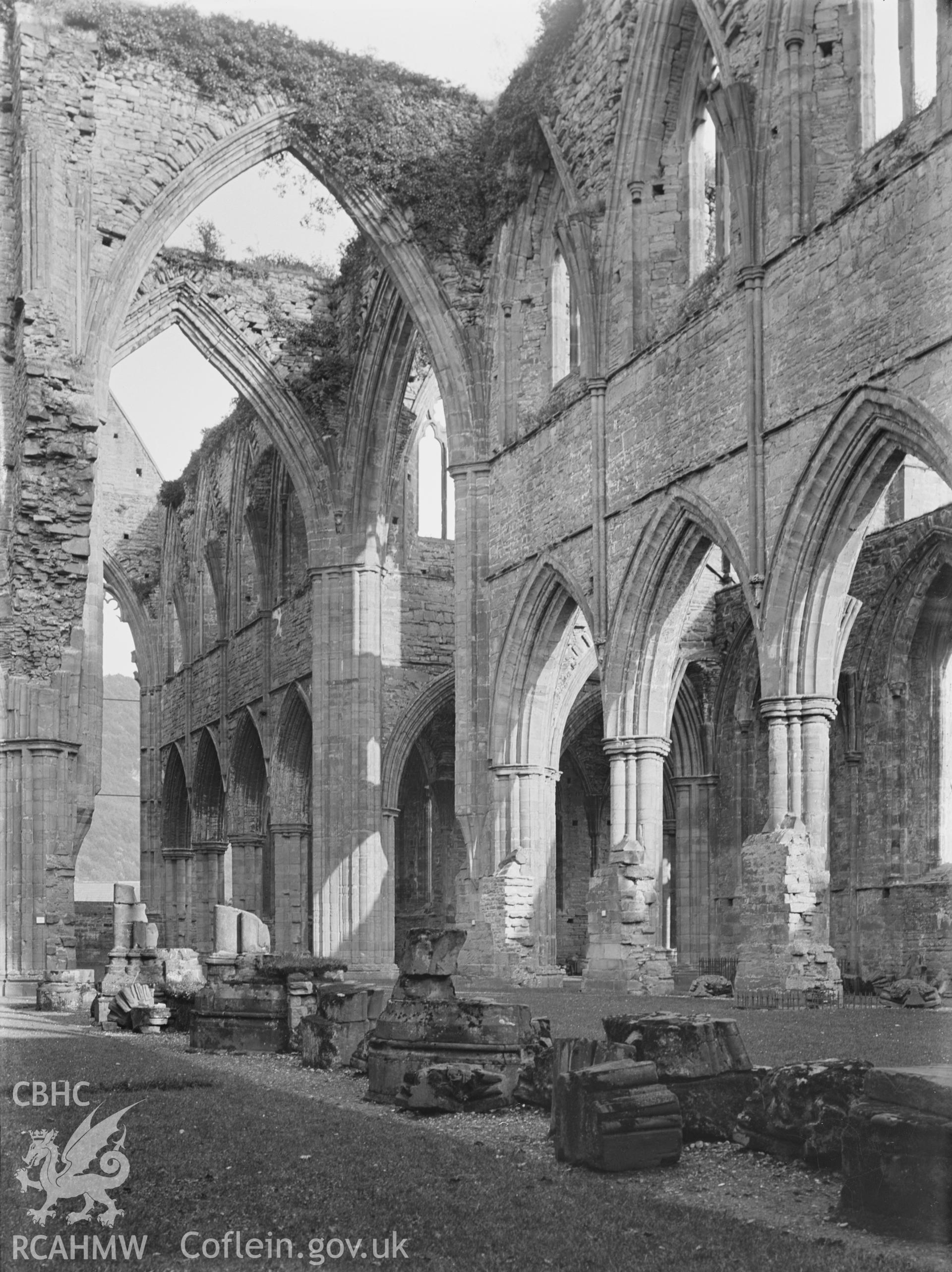 Black and white glass negative showing columns and arches at Tintern Abbey.