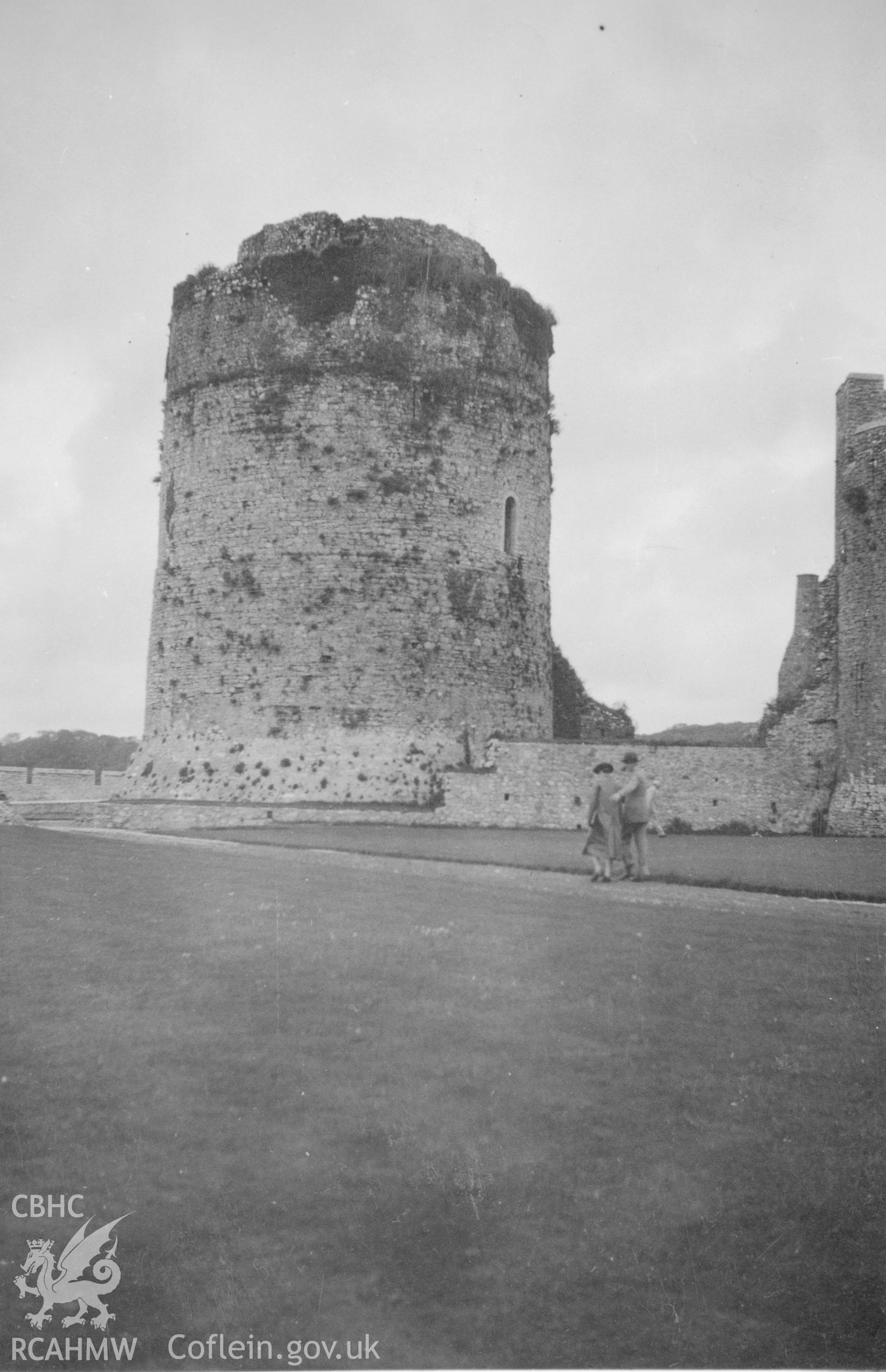 View of tower at Pembroke Castle with two figures in foreground.  Dated 1937.