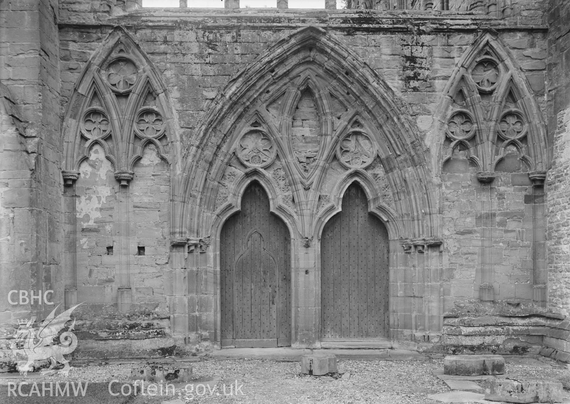 Black and white glass negative showing arches at Tintern Abbey.