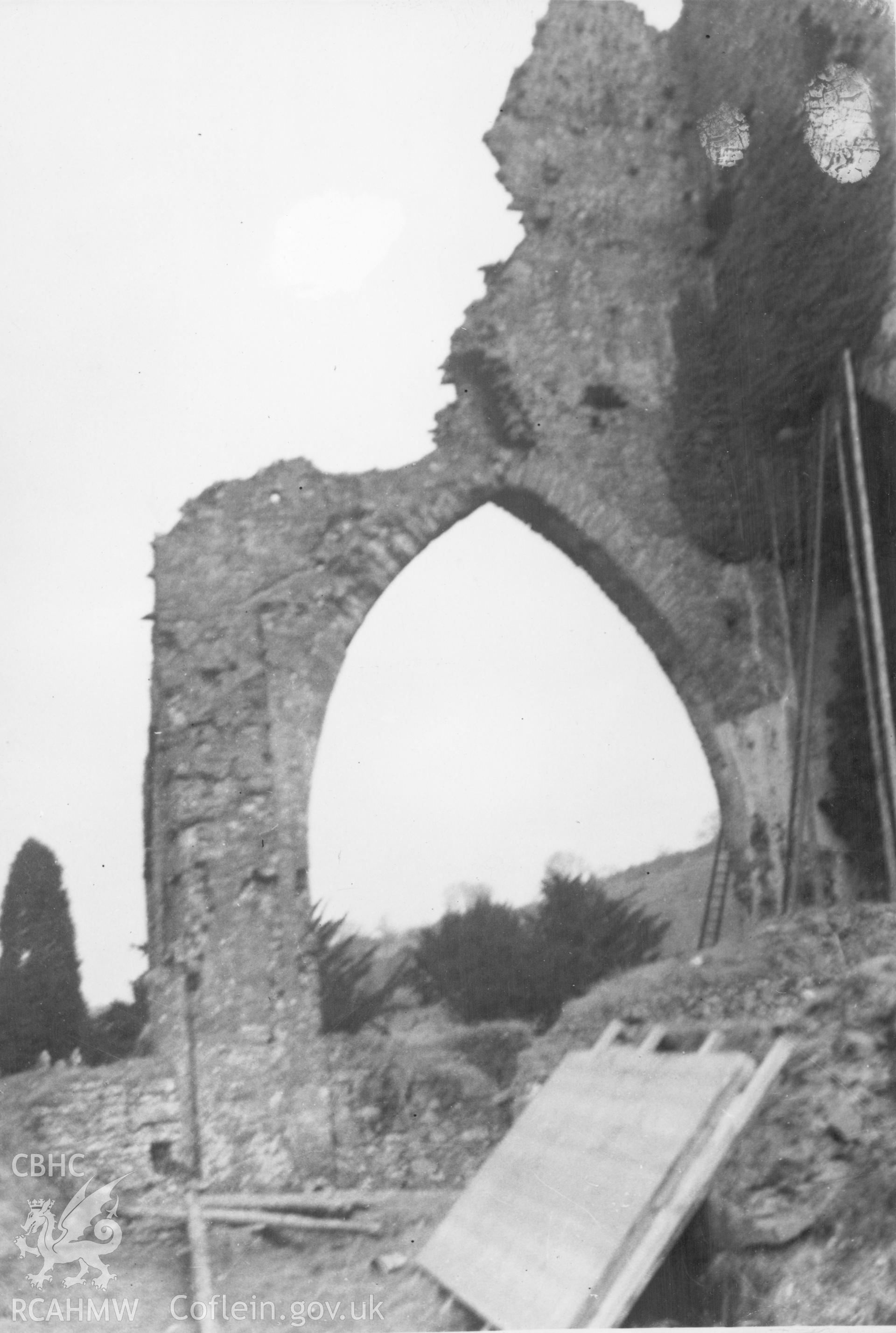 Detail of high arch with long ladders and scaffolding poles at the side, presumably in preparation for repair and restoration at Talley Abbey.