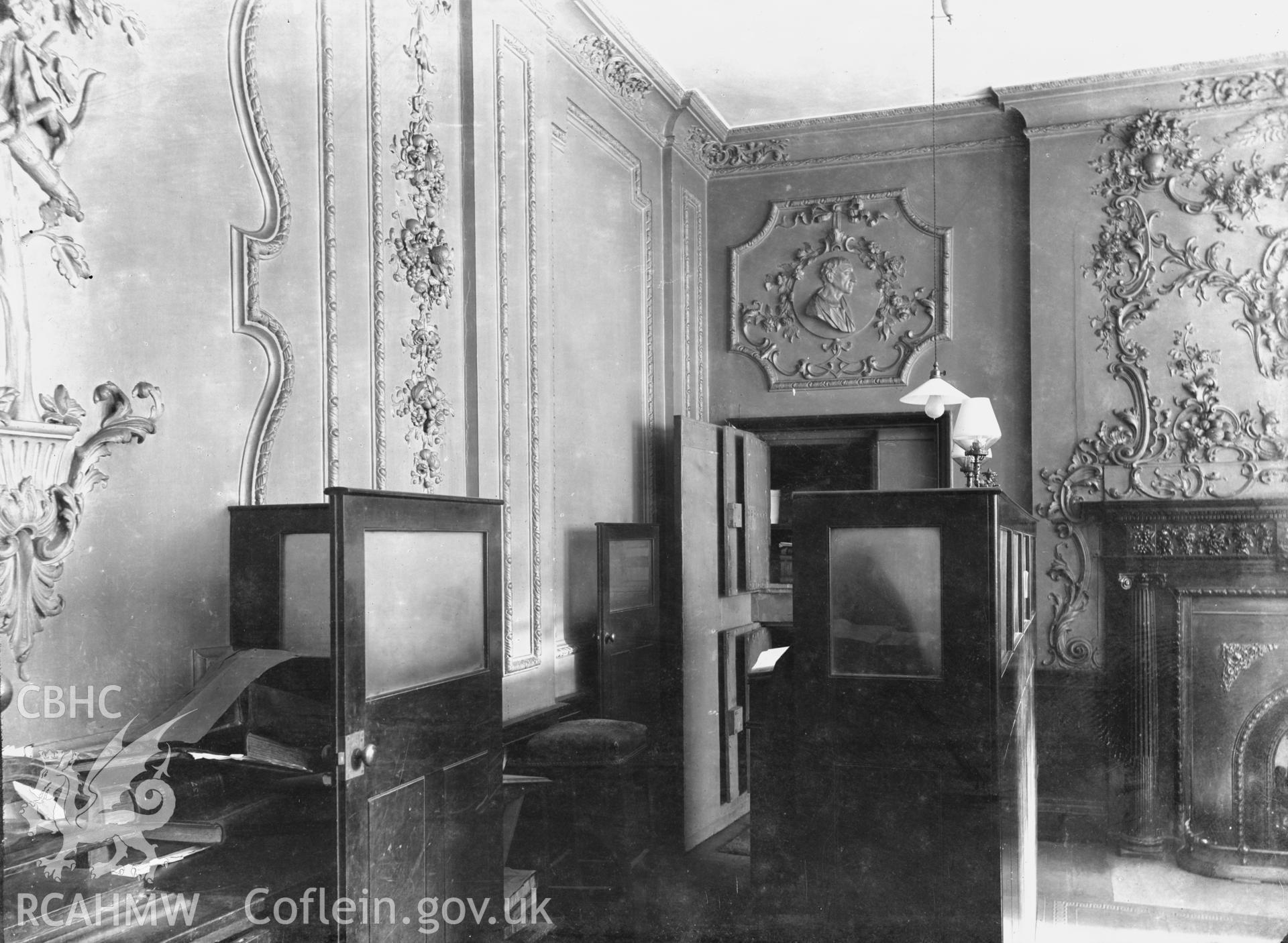 Black and white glass negative showing view of  decorative plaster walls in the study of unknown house.