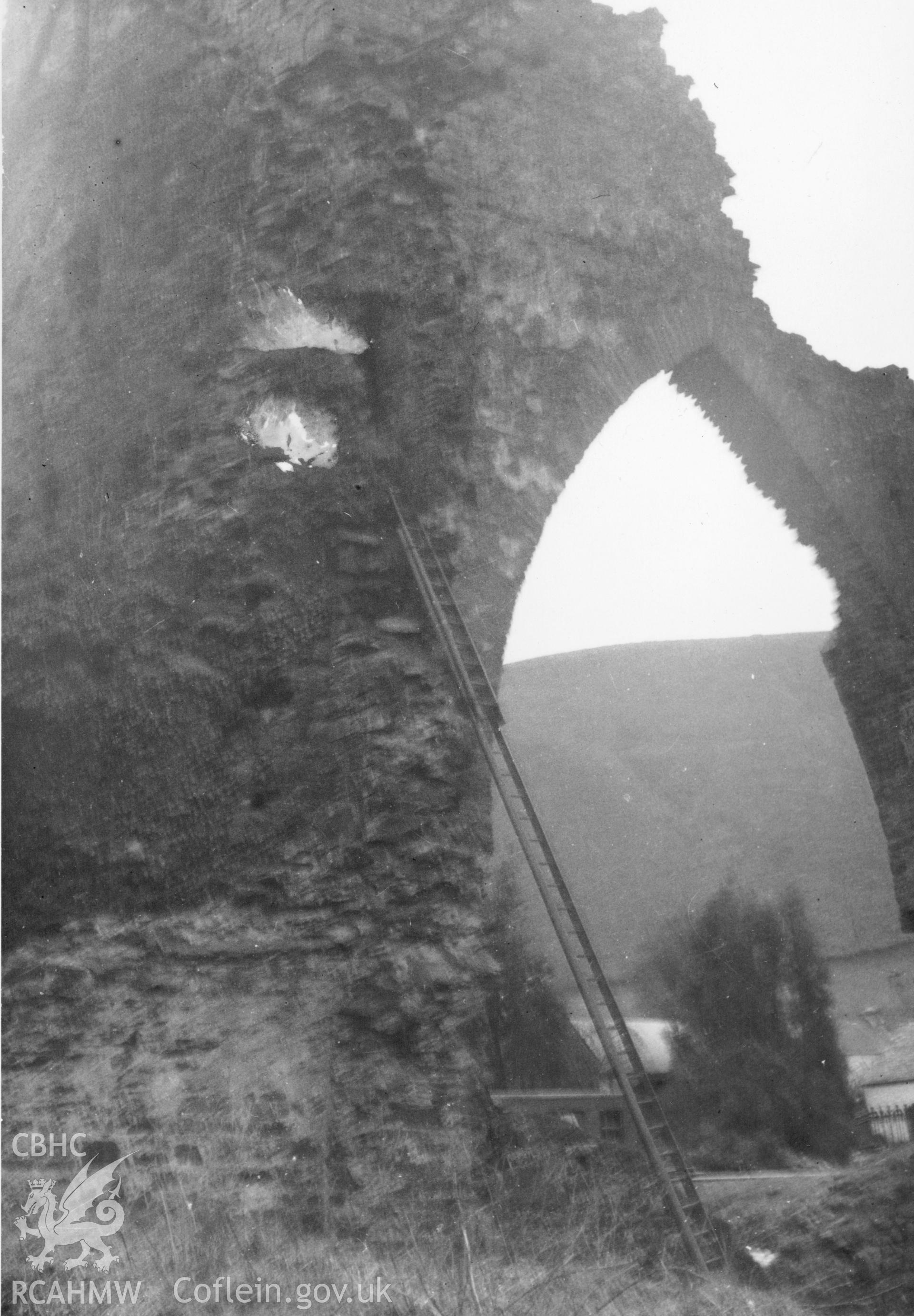 Detail of high arch with long ladder at the side, presumably in preparation for repair and restoration at Talley Abbey.