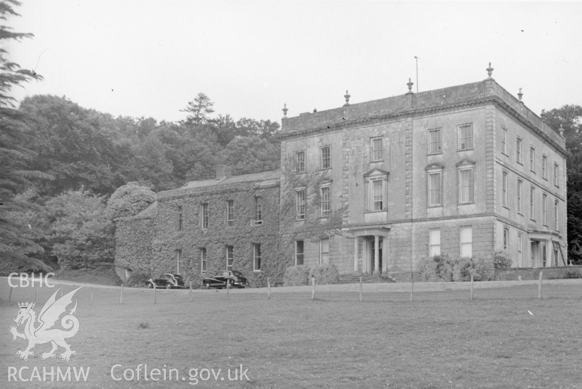 Front and side elevation of Plas Taliaris with 2 cars parked outside.