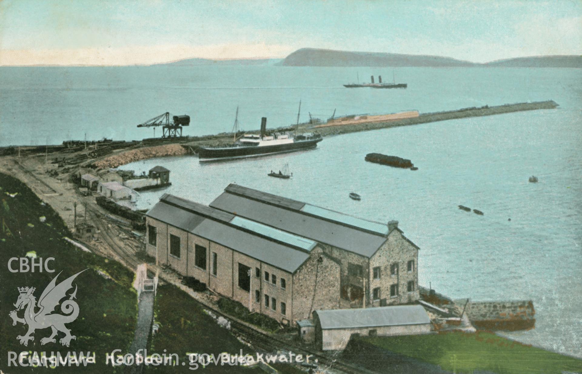 Fishguard Harbour; colour picture postcard, postmark July 1908., showing view of the breakwater at Fishguard with an elegant steam yacht (possibly a Trinity House vessel) moored alongside.