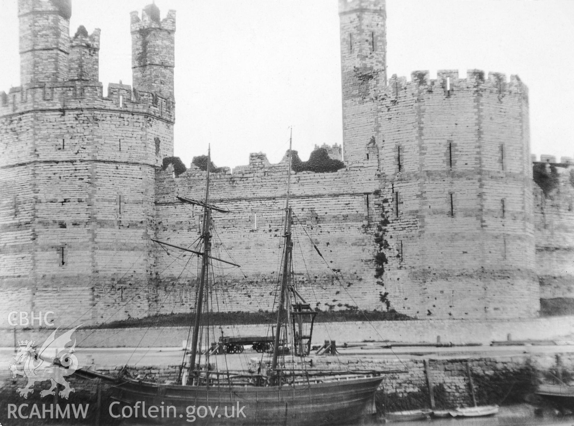 Caernarfon Castle; photograph showing the eastern side of the entrance to Afon Seiont and topsail schooner lying aground against the harbour wall.