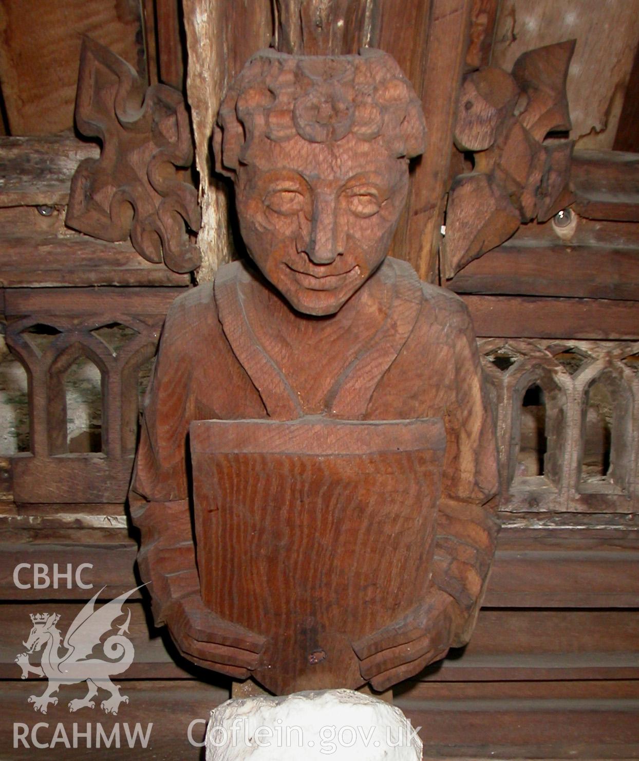 Carved wooden head between Trusses V & VI, South side.