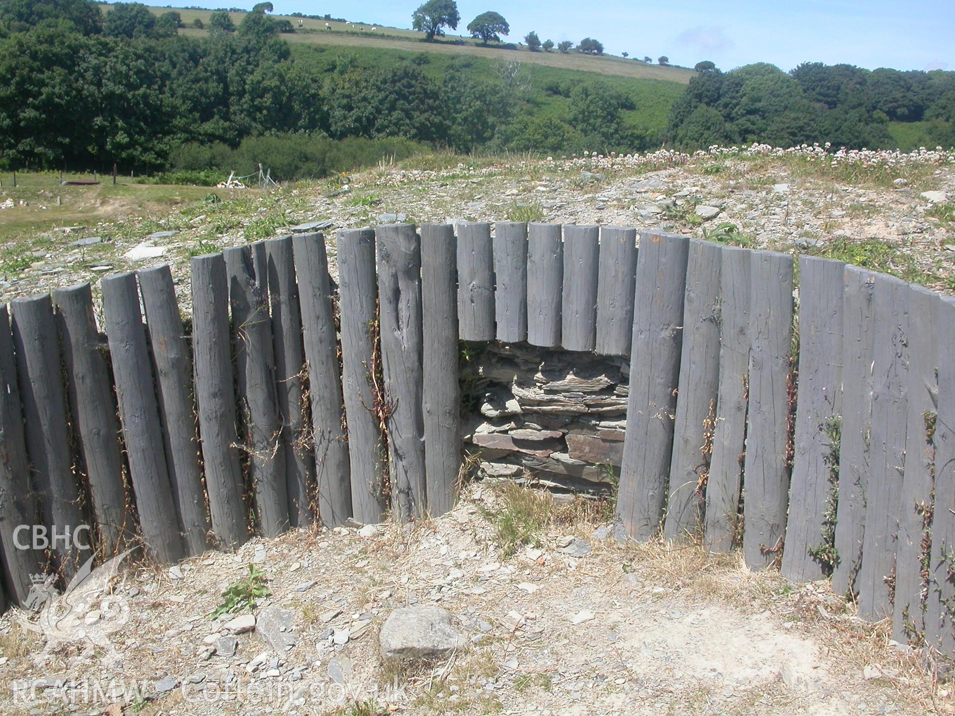 Reconstructed east timber side to north gate with part of stone revetting exposed.