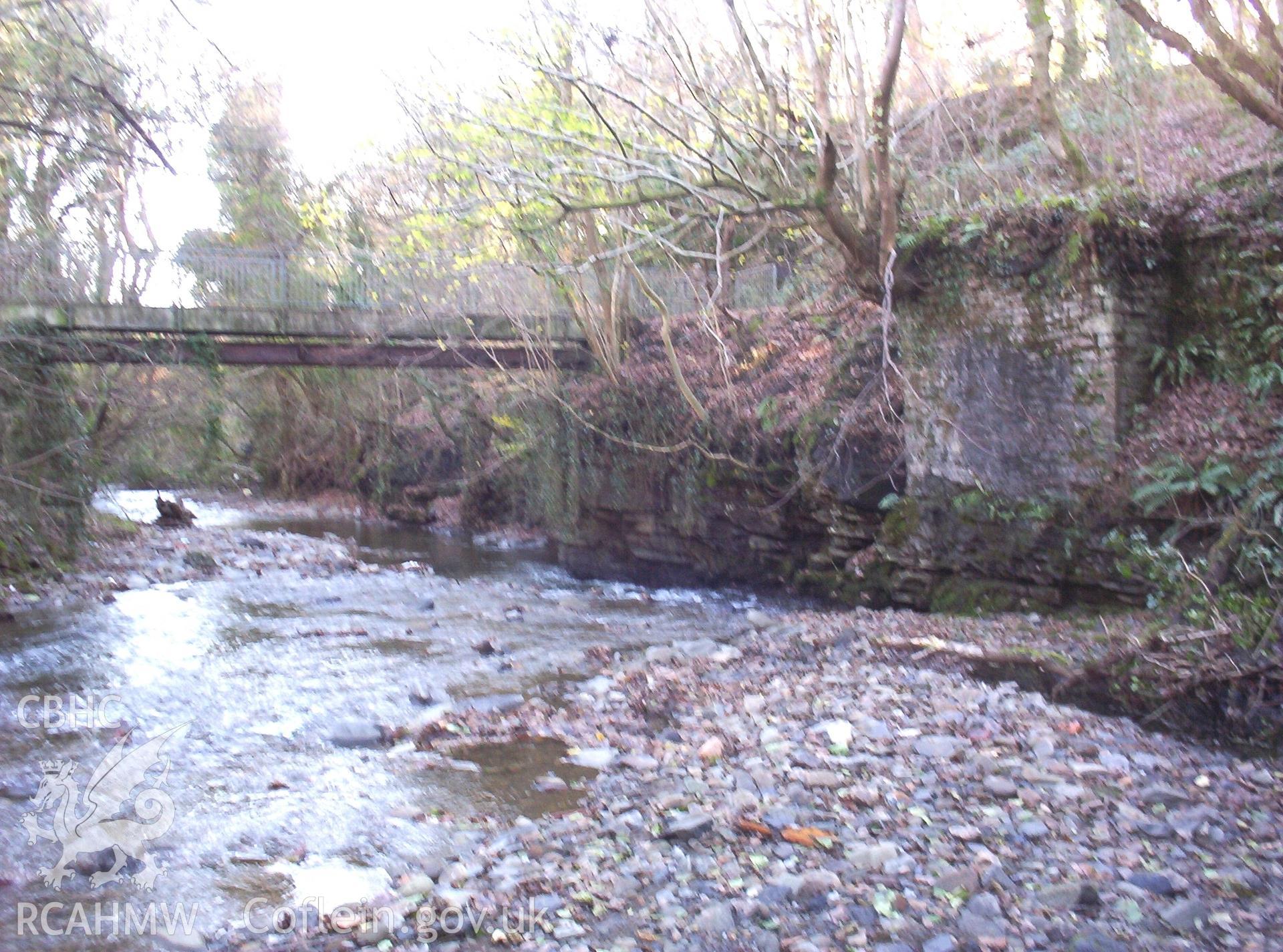 Looking downstream (south-east) from culvert mouth (on right corner of photo) with abutment of railway bridge on right beyond.