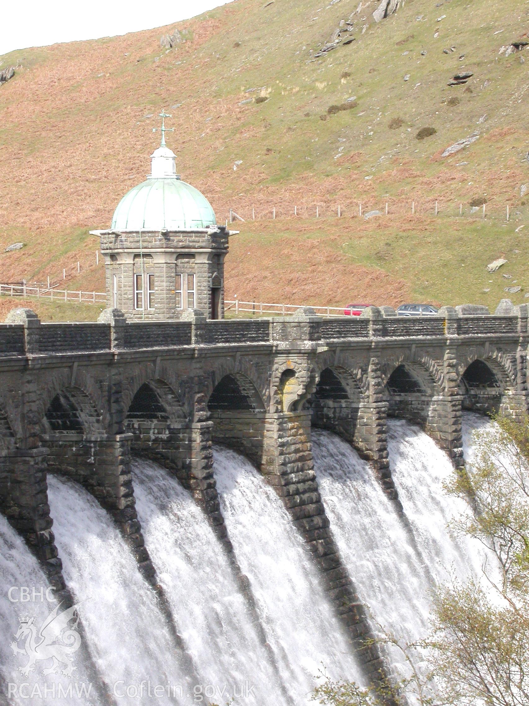 Dam and valve tower with hillside beyond.