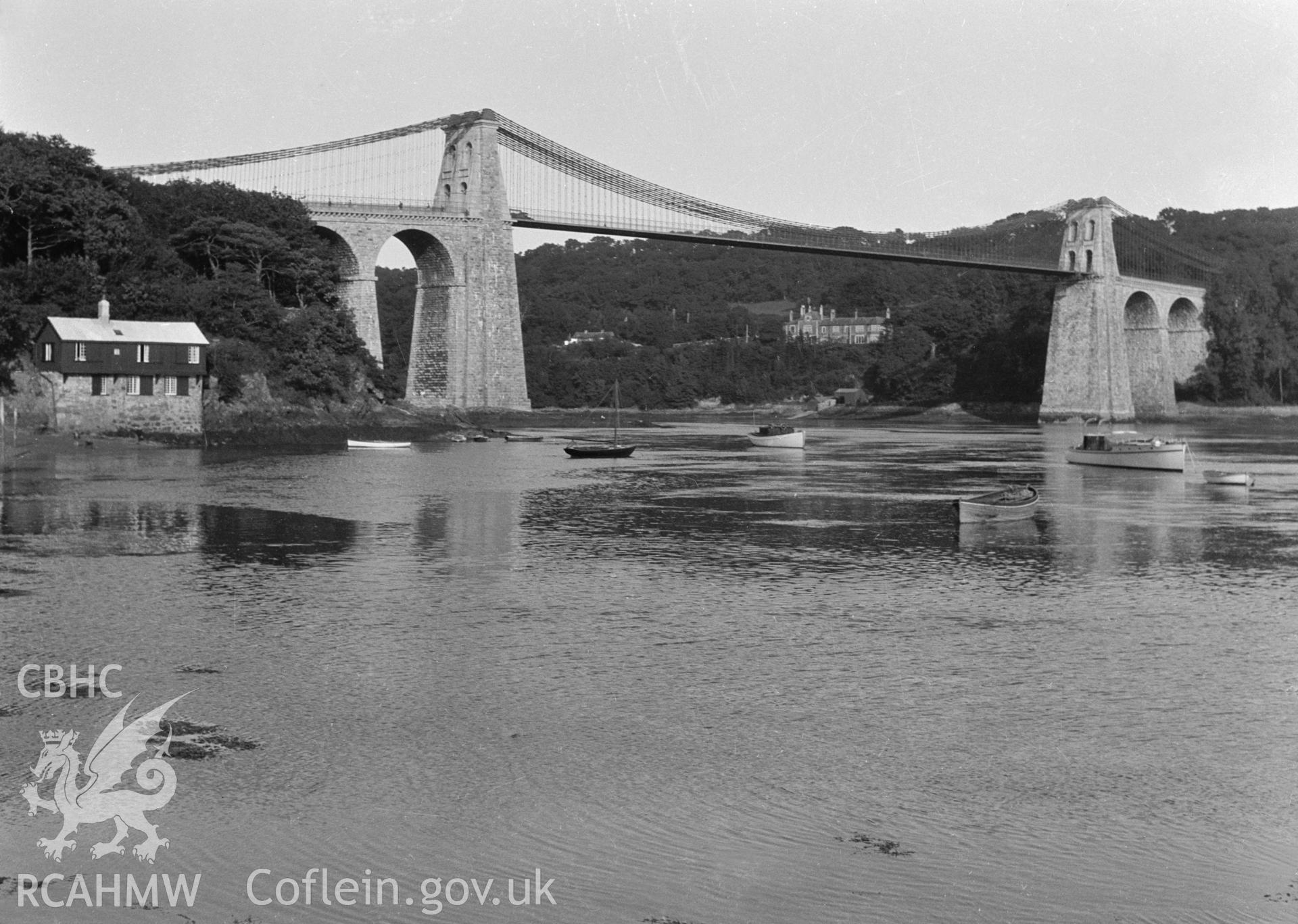 Black and white print of Menai Suspension Bridge, Menai Bridge, taken from the Ministry of Works Collection.