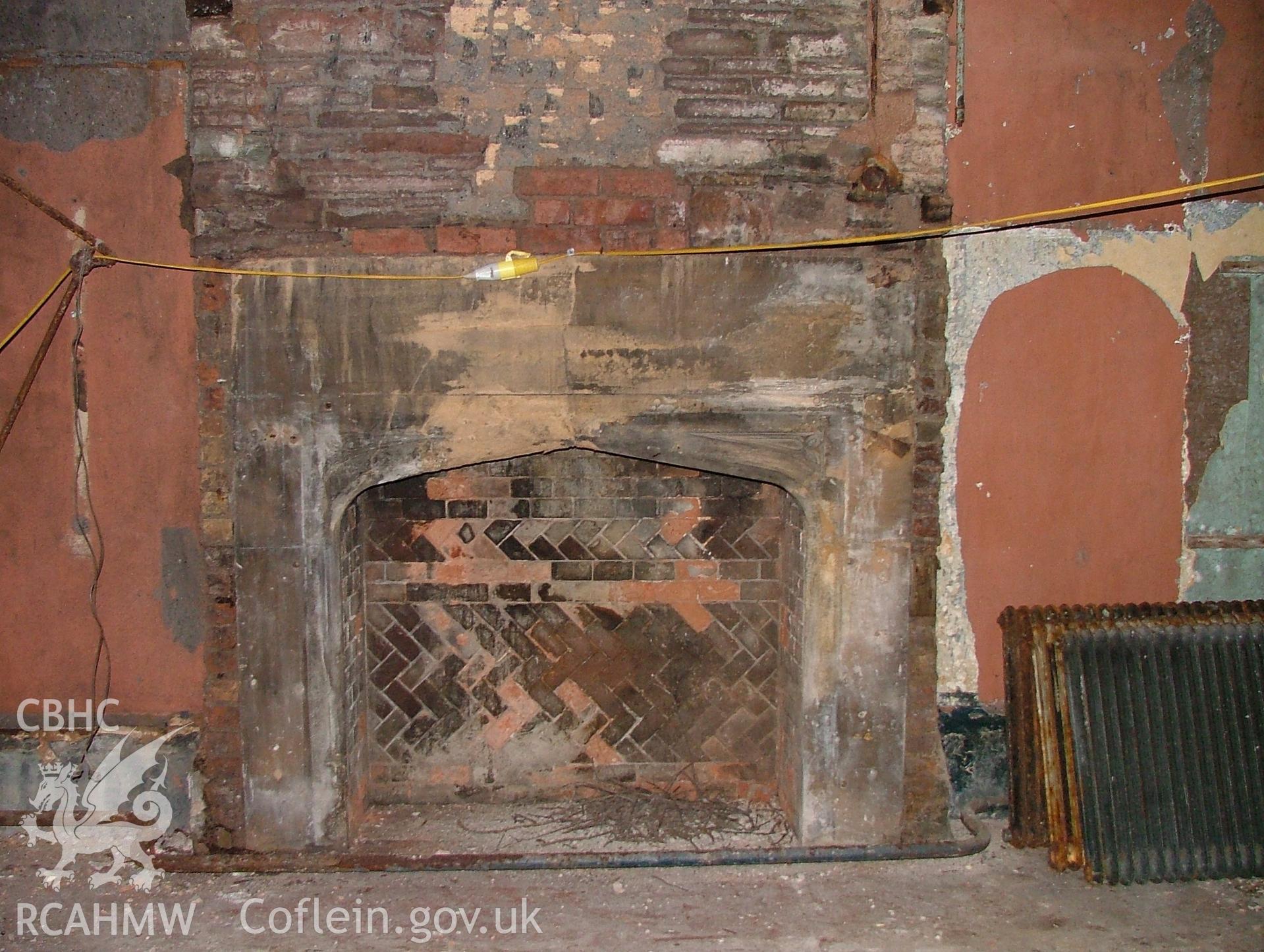 Detail of fireplace at the north-east end of the large ground floor room to the north-east of the hall at Malpas Court, looking north-east.