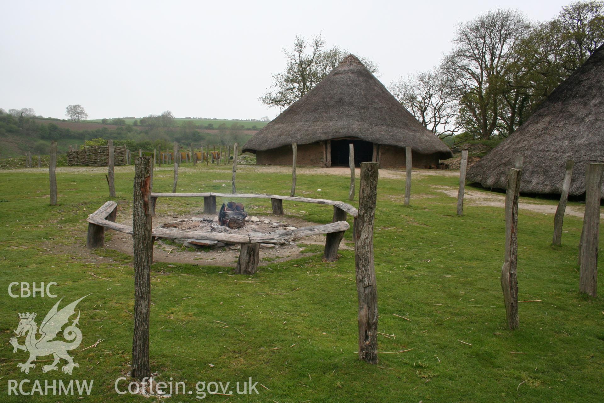 Castell Henllys, central fireplace and round houses beyond