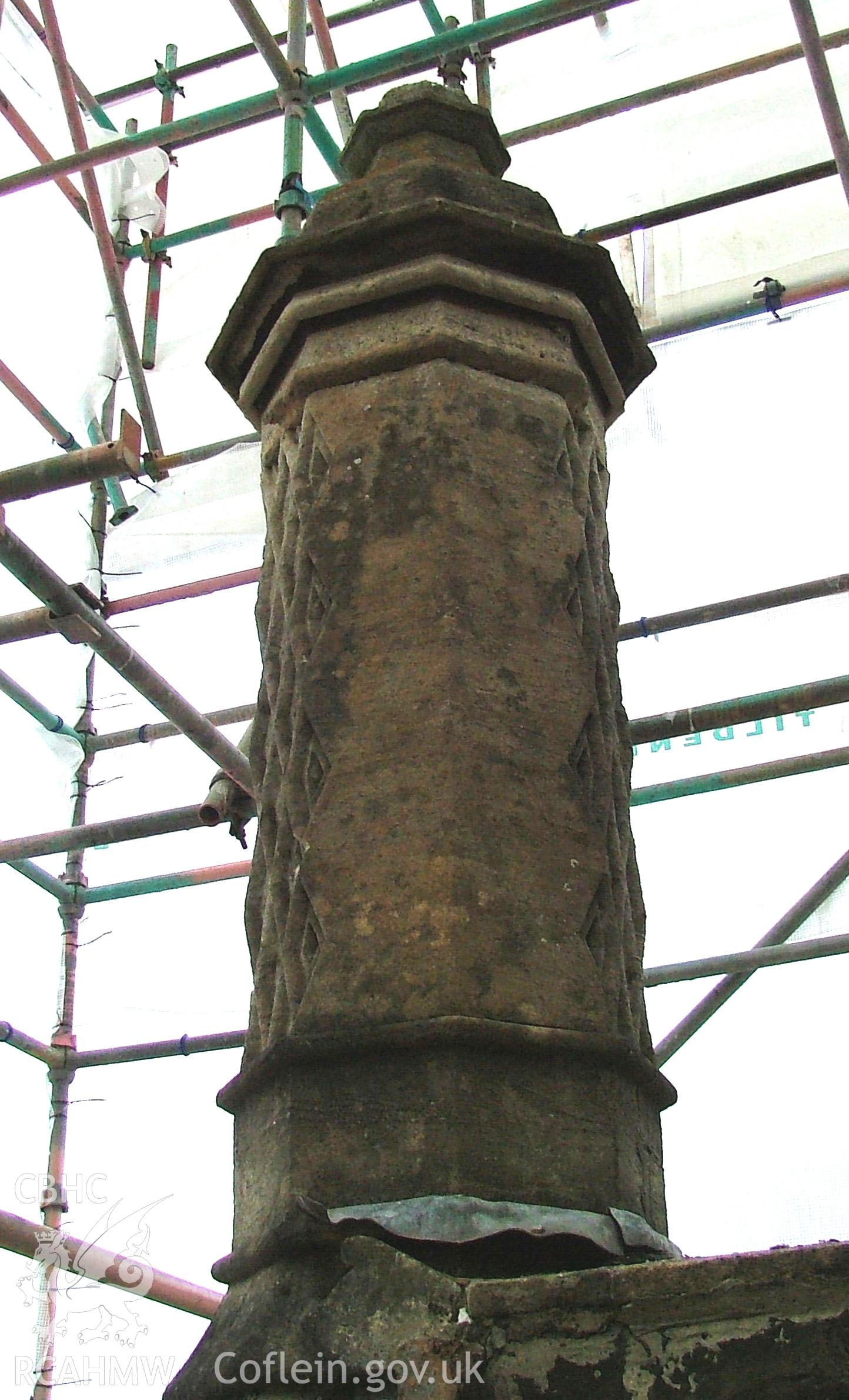 Exterior of stone chimney with carved chevron decoration.