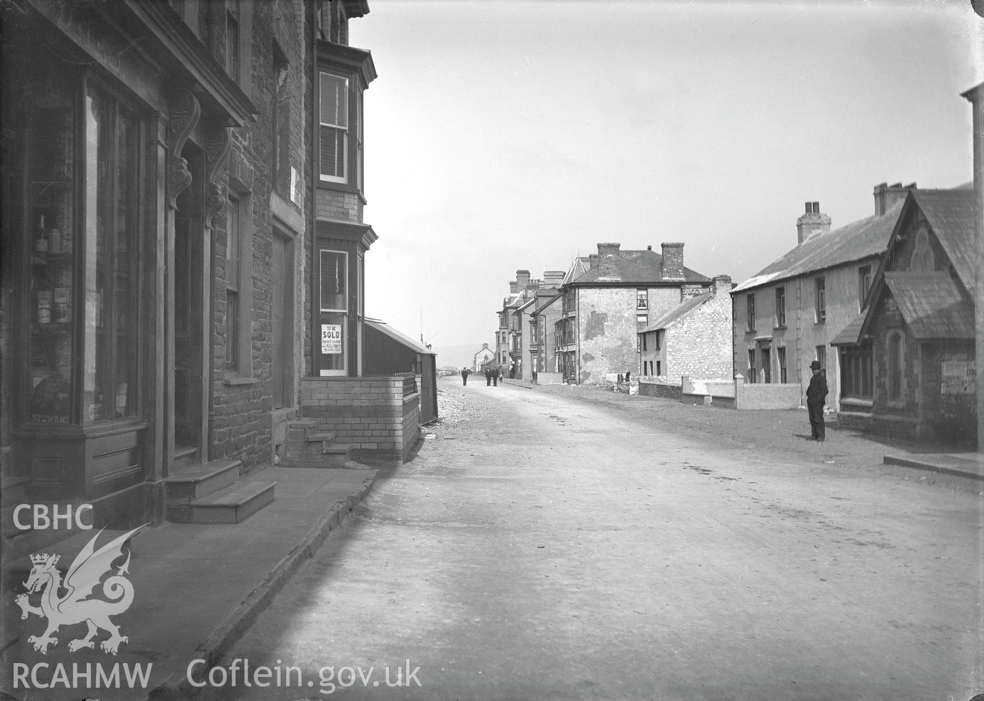 Black and white image dating from c.1910 showing Borth High Street,  taken by Emile T. Evans.