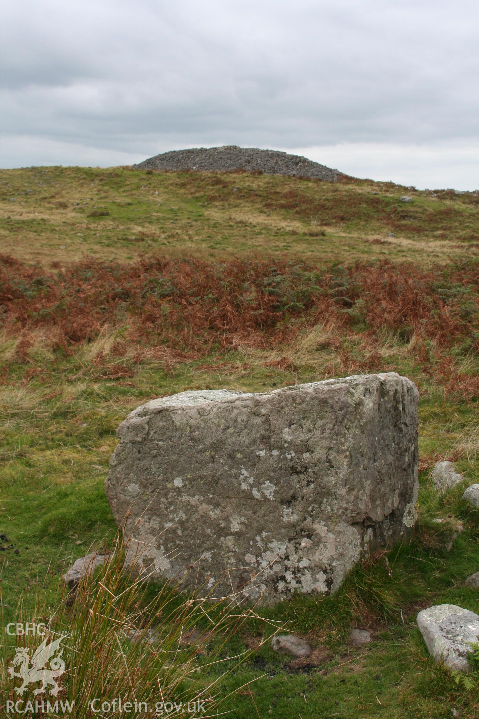 Possible standing stone in south-east hillfort interior, view north-west towards summit cairn.