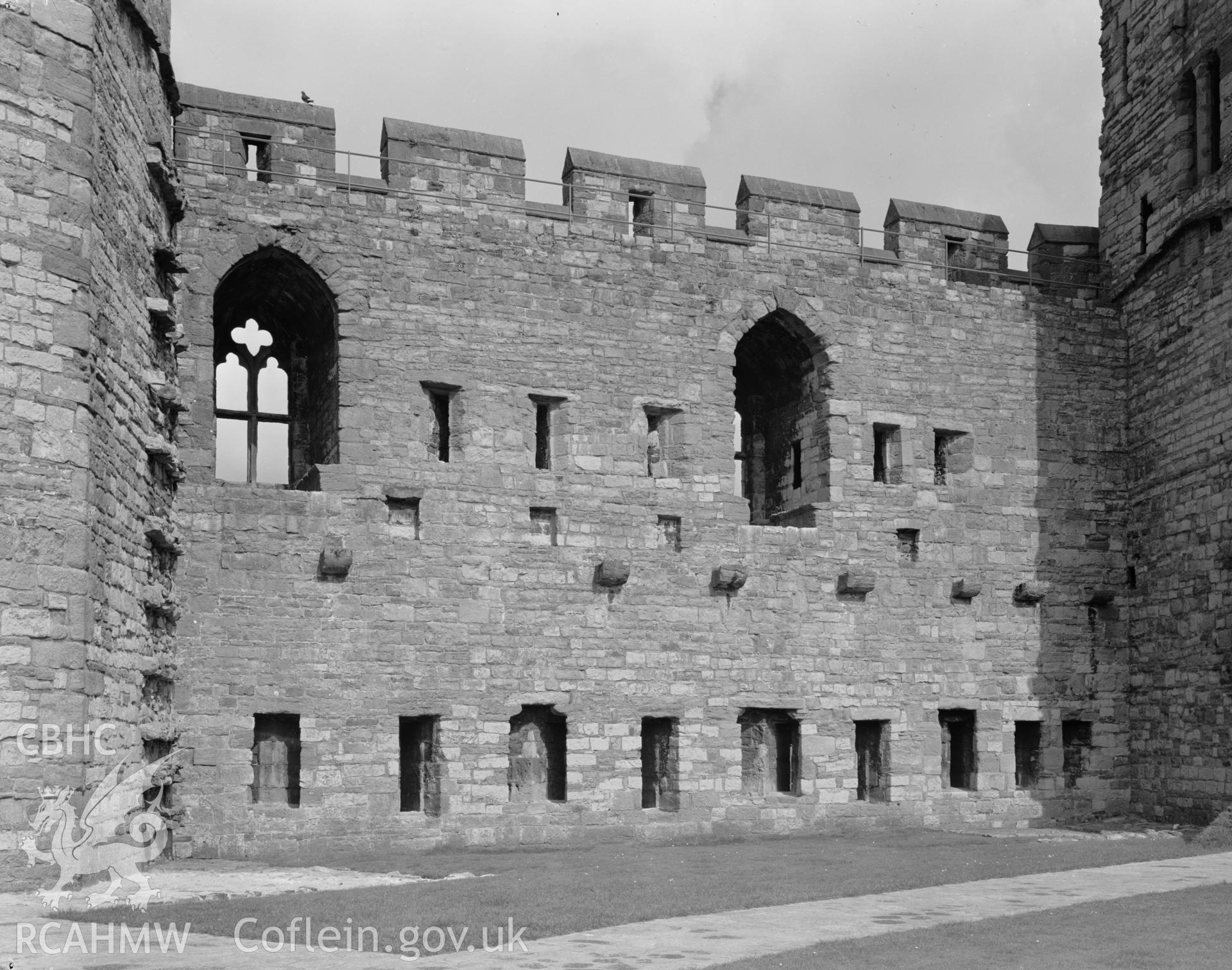 D.O.E photograph of Caernarfon Castle - multiple arrow loops between granary and north east towers.