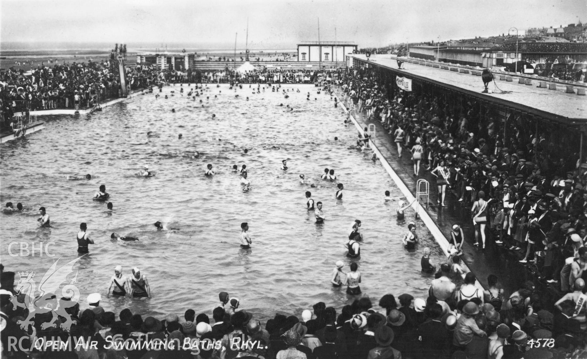 Digitised copy of a 1949  black and white postcard showing the Open Air Swimming Pool, Rhyl, produced by RA Postcards Ltd and loaned for copying by Daryl Leeworthy.