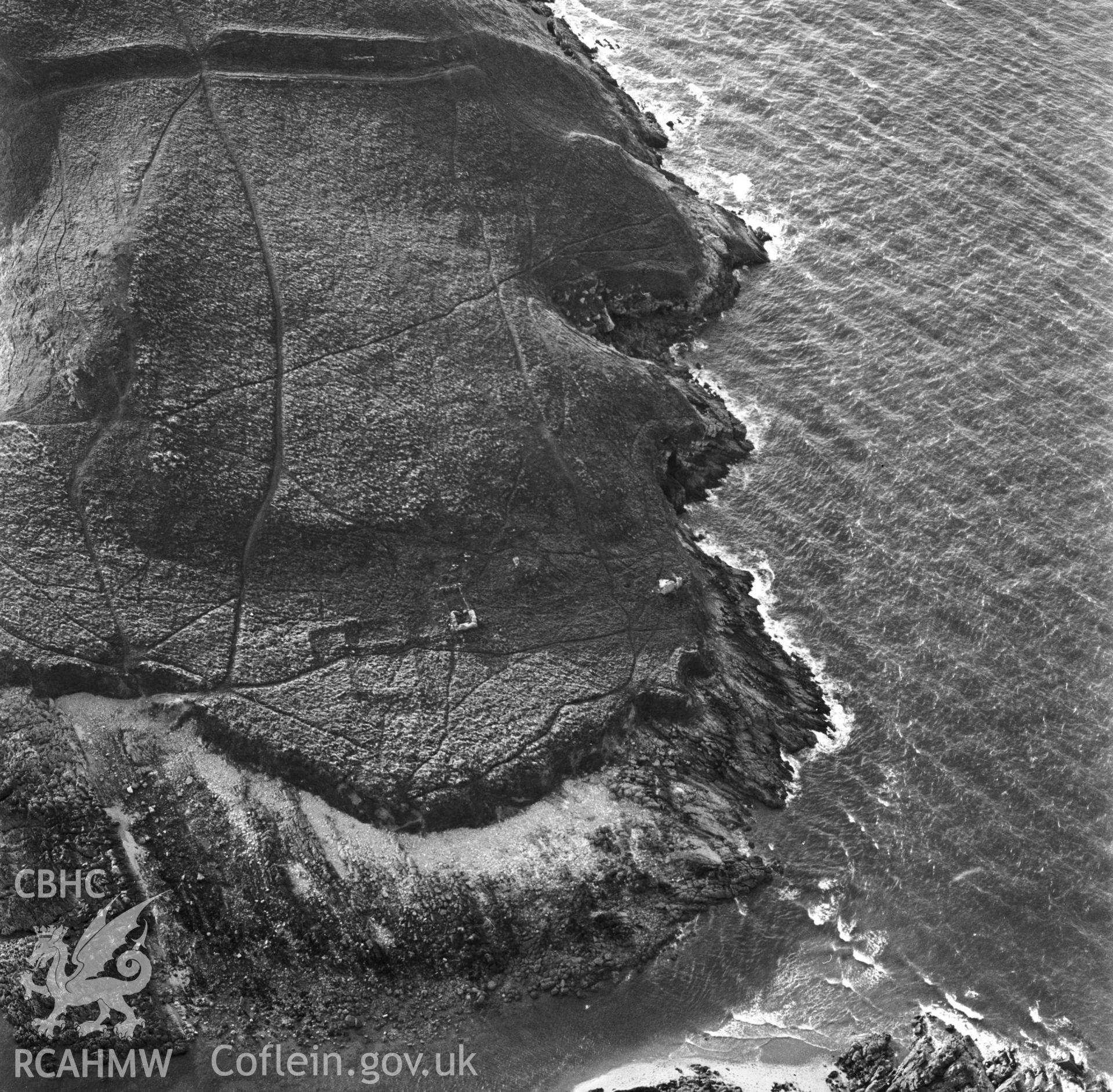 RCAHMW Black and white oblique aerial photograph of medieval hermitage site on Burry Holms, Llanmadog and Cheriton, taken by CR Musson on 14/09/88