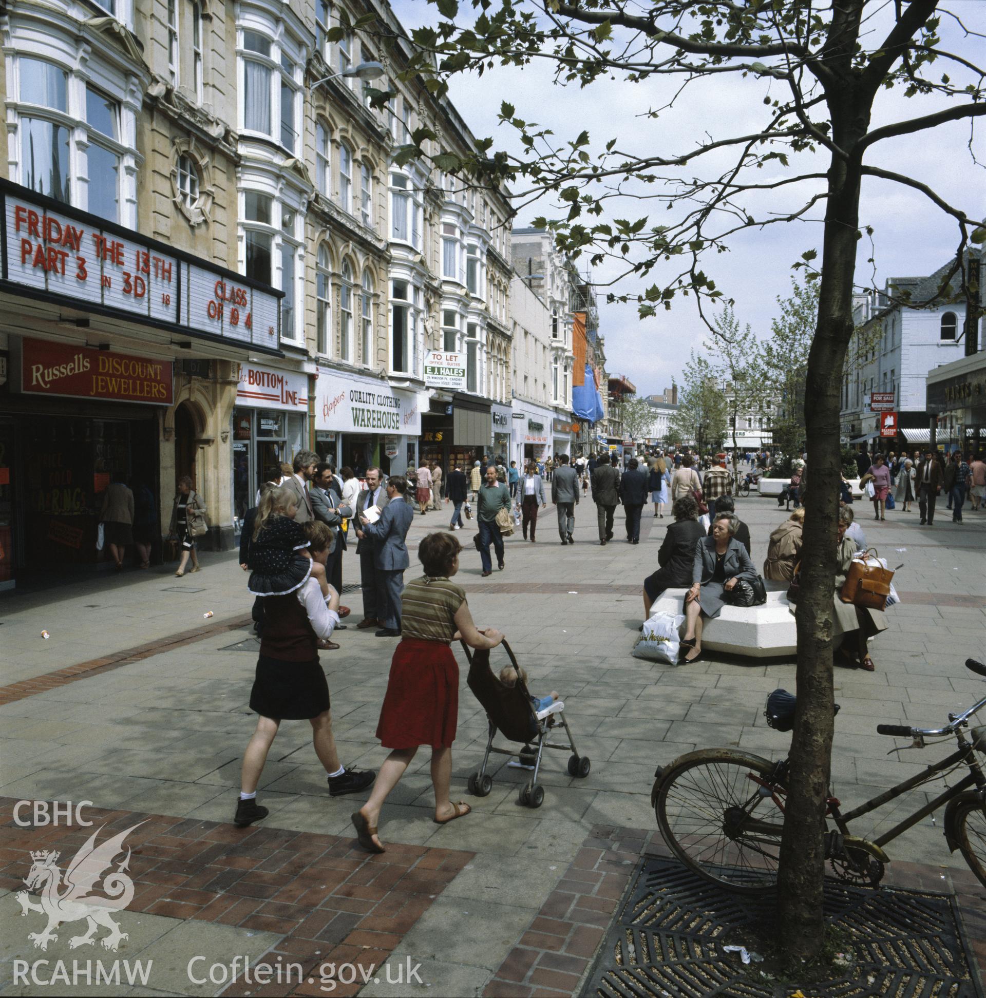 1 colour transparency showingn street scene in central Cardiff with shoppers; collated by the former Central Office of Information.