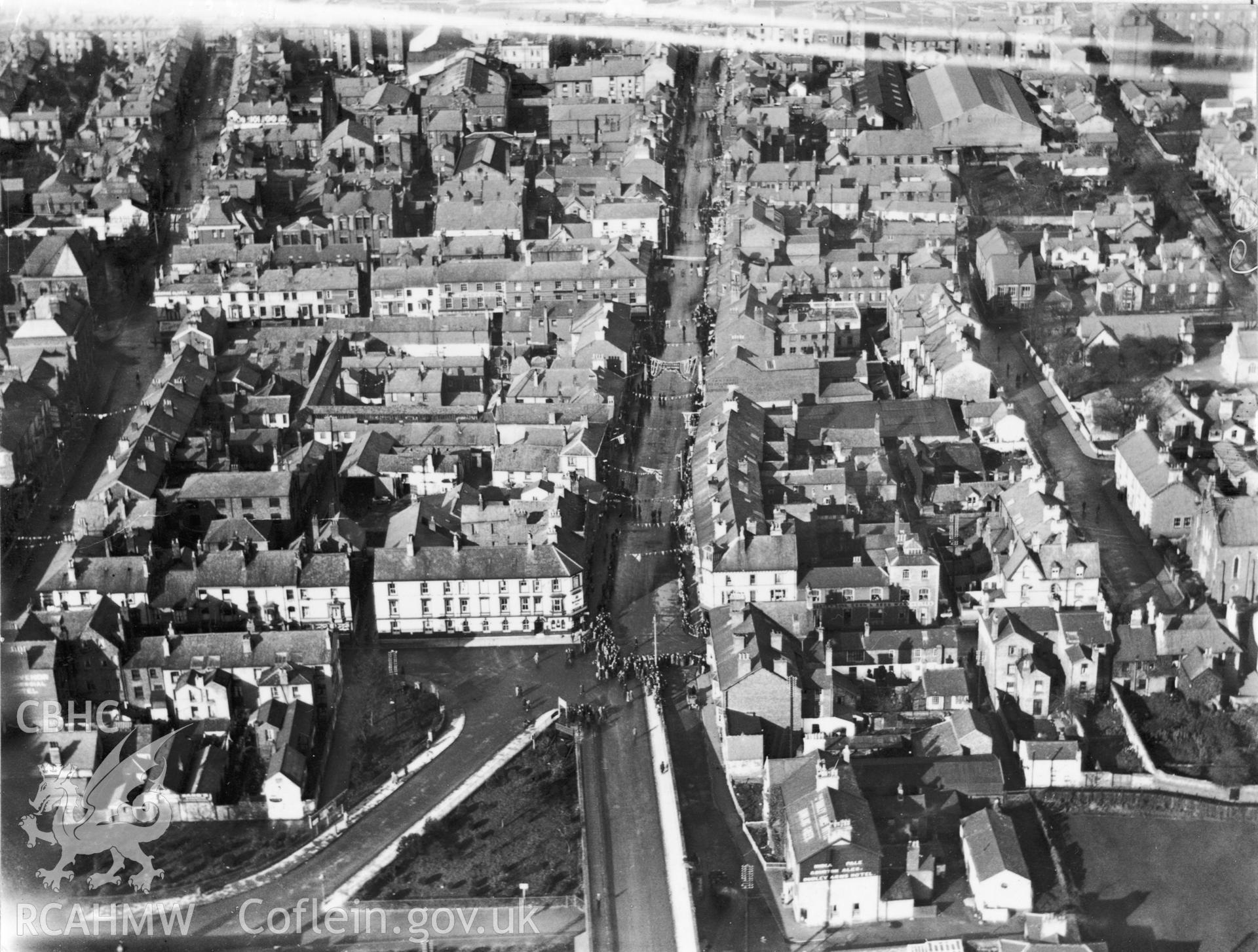Black and white oblique aerial photograph of the town of Rhyl  dated 16th November1923 showing crowds during a visit by the Prince of Wales. Aerofilms album Flints M-Z (W17).