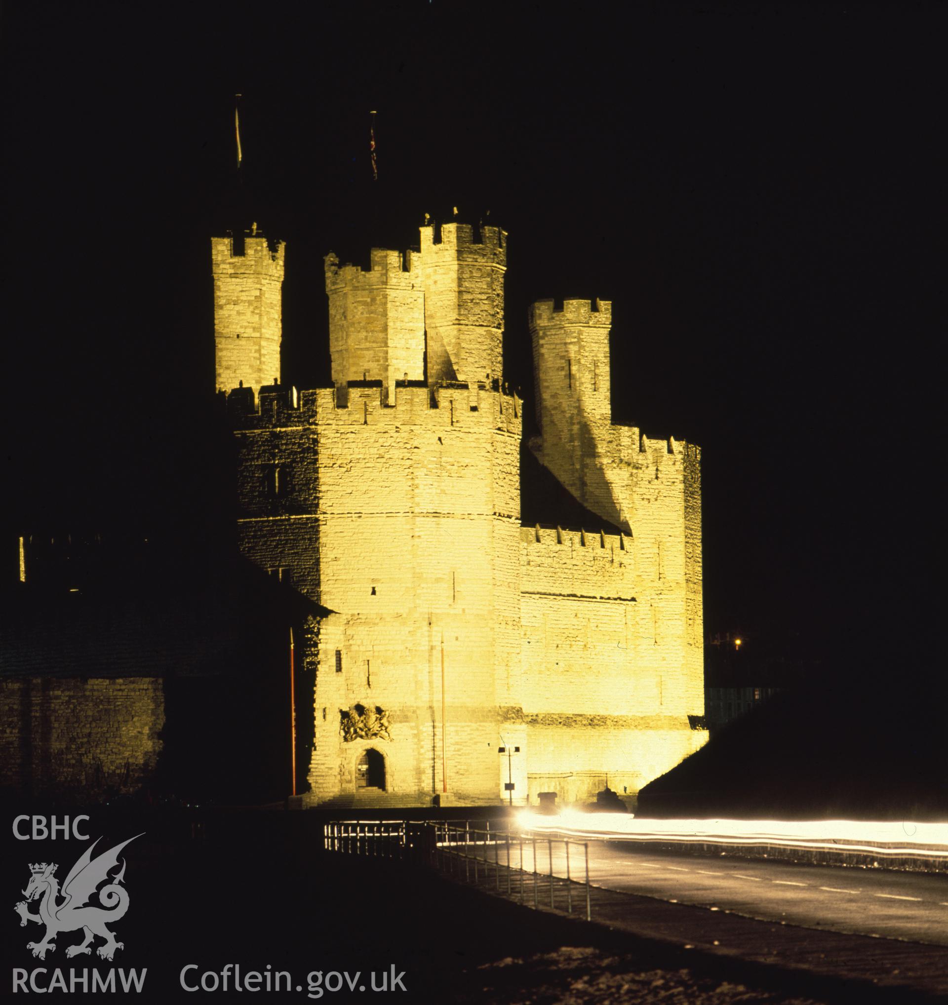 1 colour transparency showing view of Caernarfon Castle at night, undated; collated by the former Central Office of Information.