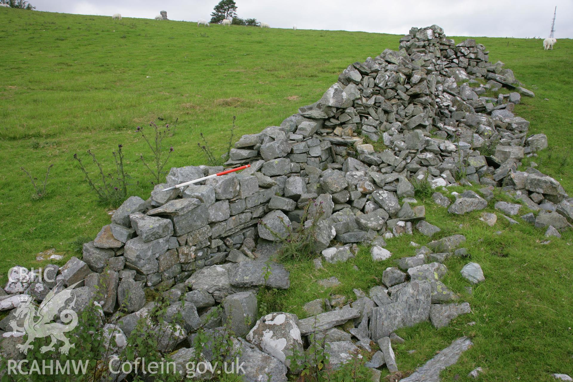 View of partly blocked Roman south-east fort gate, with fragments of Roman stonework visible