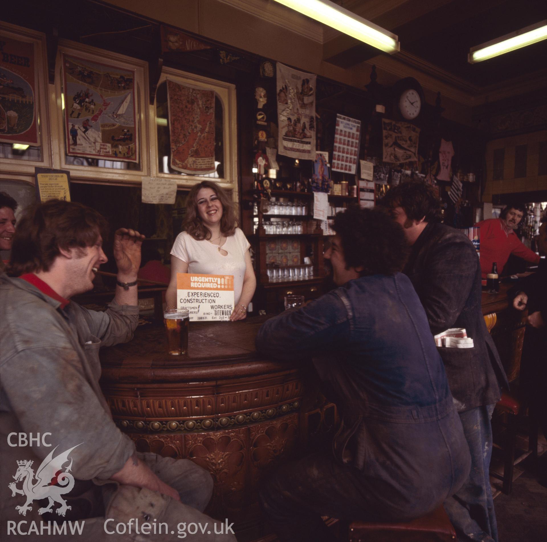 1 colour transparency showing interior view of Golden Cross Inn with figures; Butetown, Cardiff; collated by the former Central Office of Information.
