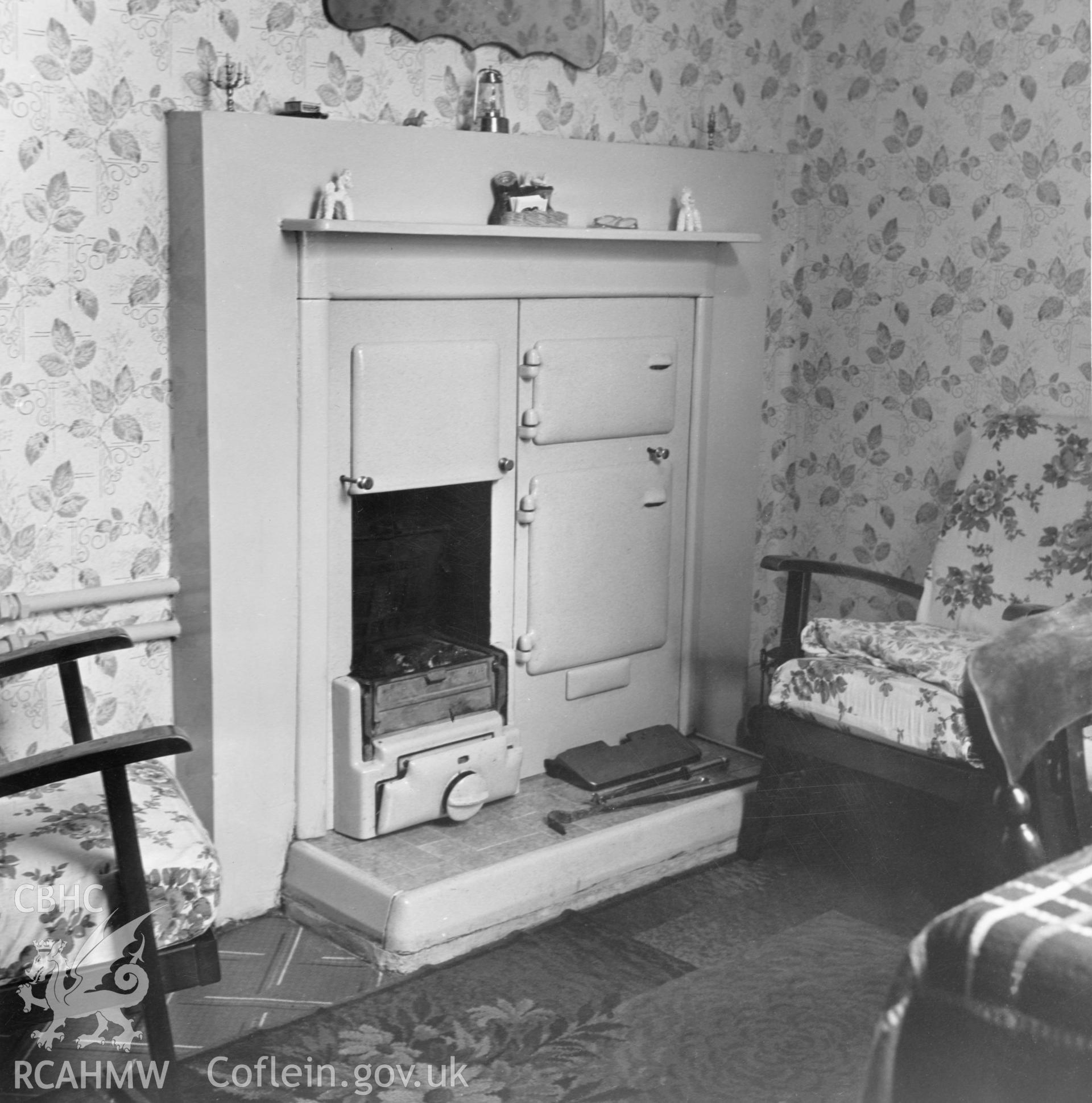 1 b/w print showing interior of a house on Council Street, Ebbw Vale (showing solid fuel cooker with back boiler), used as an illustration of the Housing Improvement Grant scheme for exhibitions held at Ministry of Housing stands at agricultural shows (1960); collated by the former Central Office of Information.
