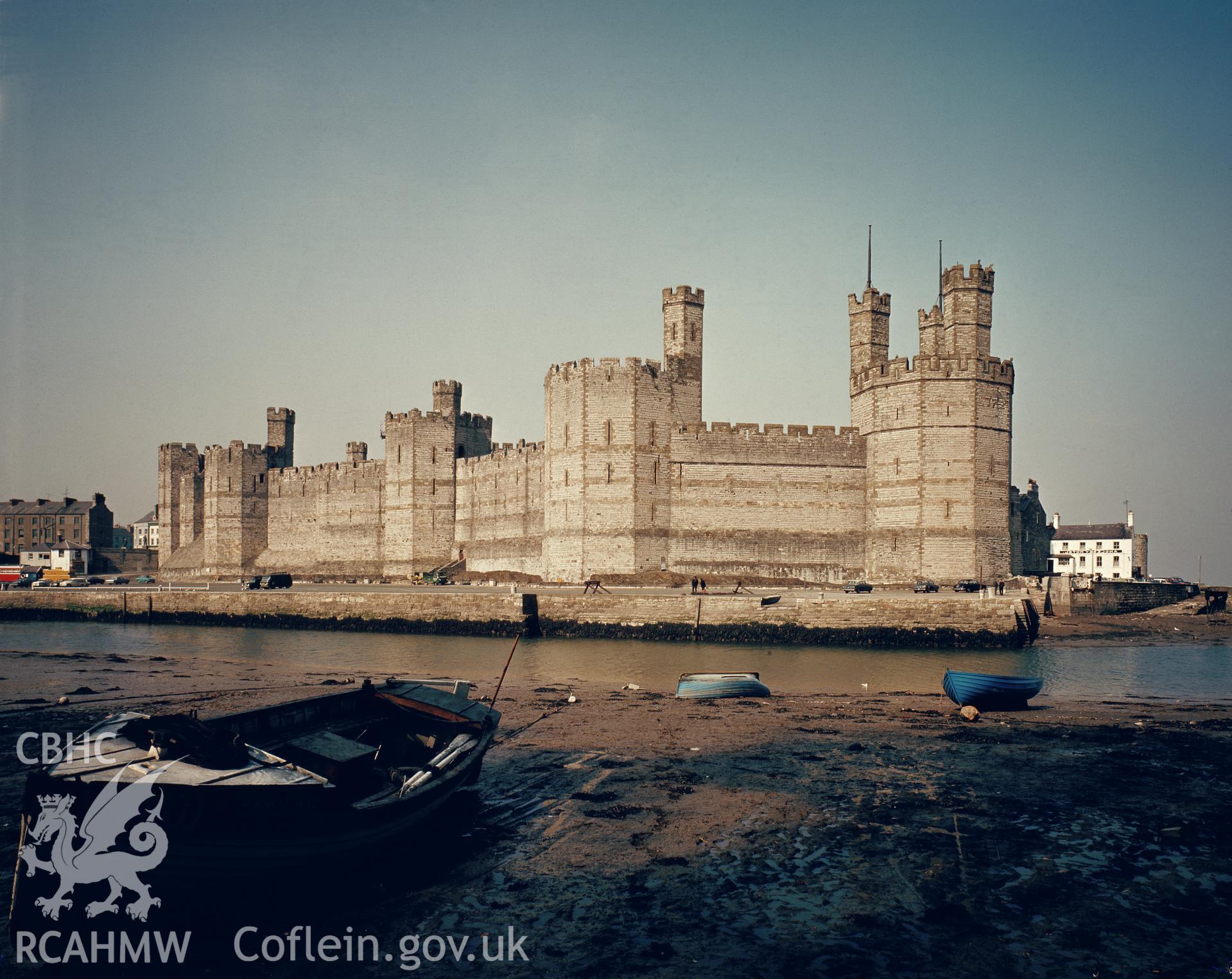 1 colour transparency showing view of Caernarfon Castle (West wall and the Harbour Quay); collated by the former Central Office of Information.