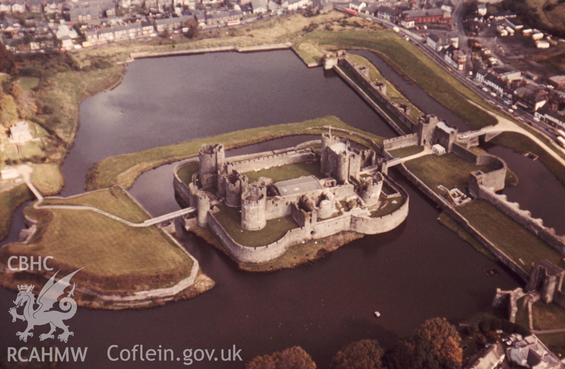 1 colour transparency showing aerial oblique view of Caerphilly Castle, undated; collated by the former Central Office of Information.