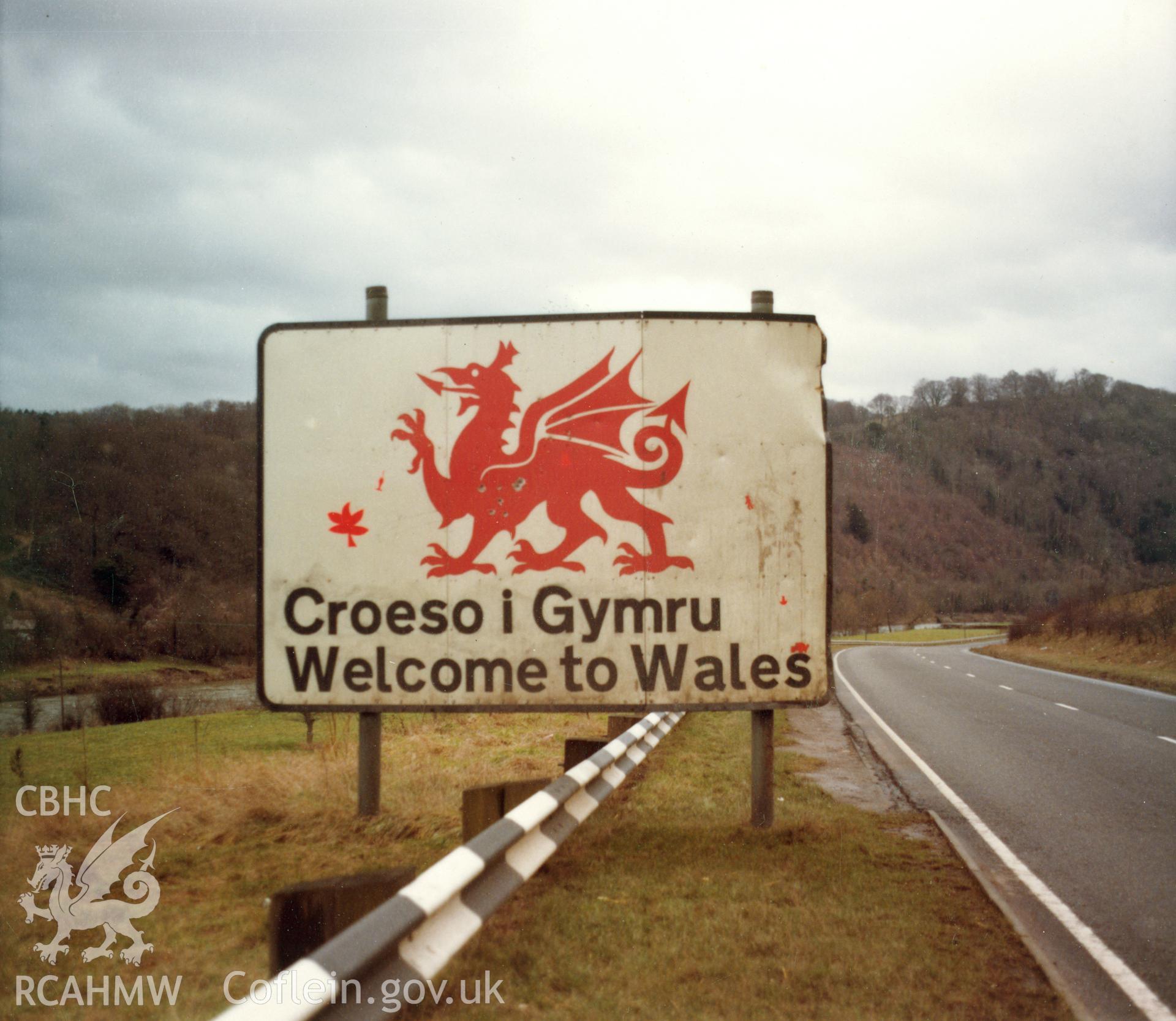Colour photograph (large contact print) showing bilingual 'Croeso i Gymru / Welcome to Wales' sign; collated by the former Central Office of Information.