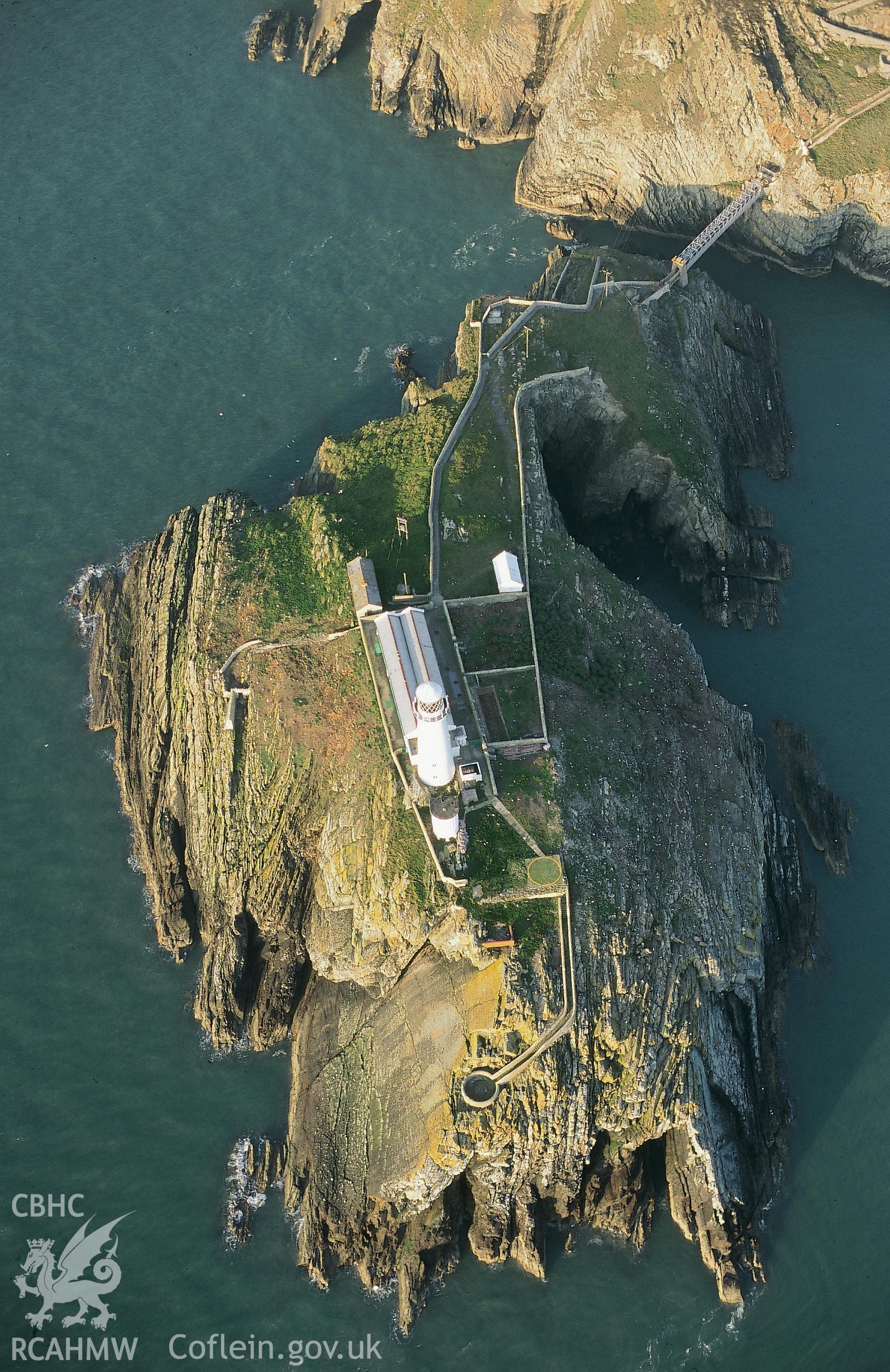 RCAHMW colour slide oblique aerial photograph of South Stack Lighthouse, Trearddur, taken on 28/04/1999 by Toby Driver