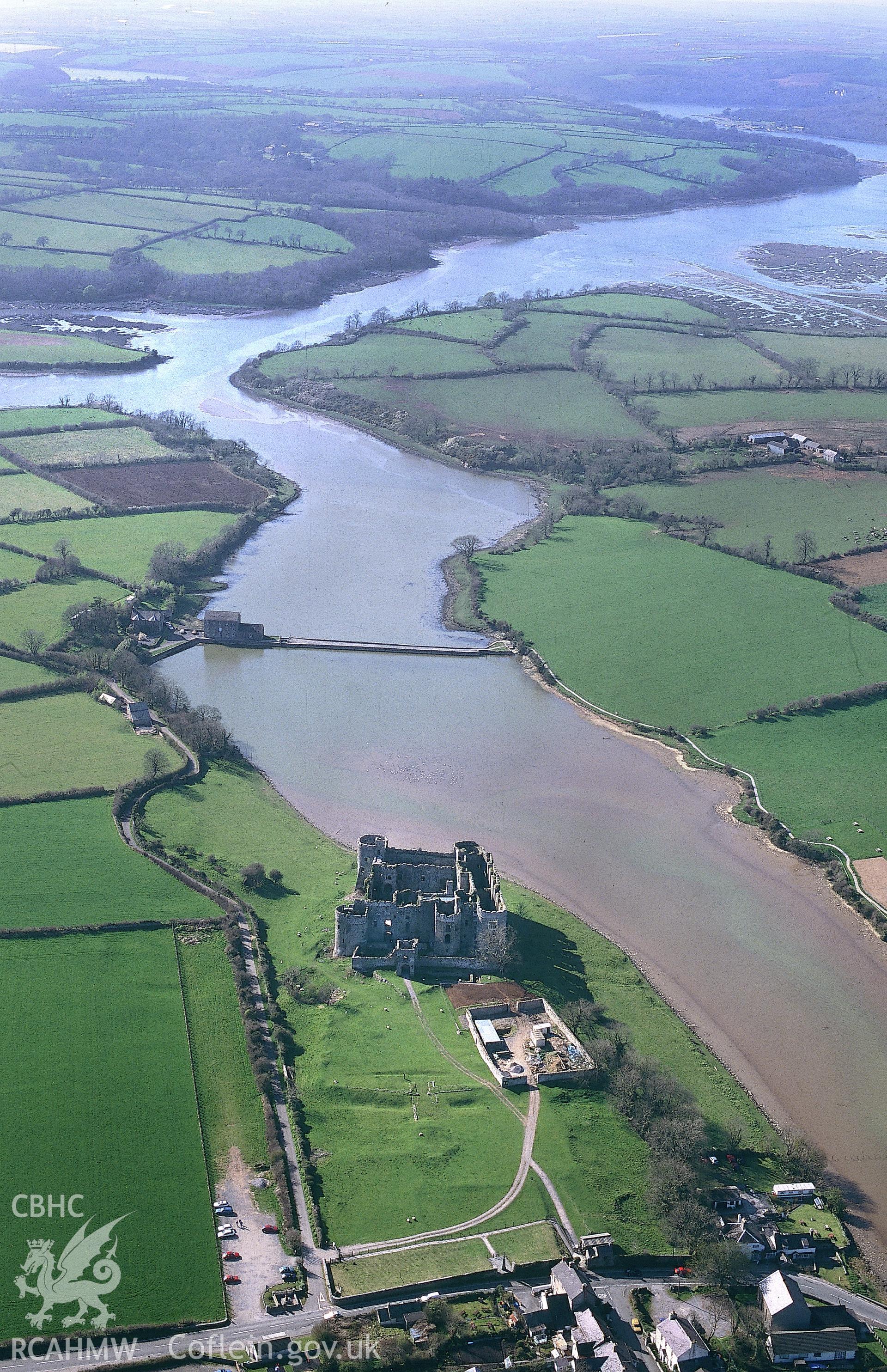 RCAHMW colour oblique aerial photograph of Carew Castle and area. Taken by C R Musson on 13/04/1995