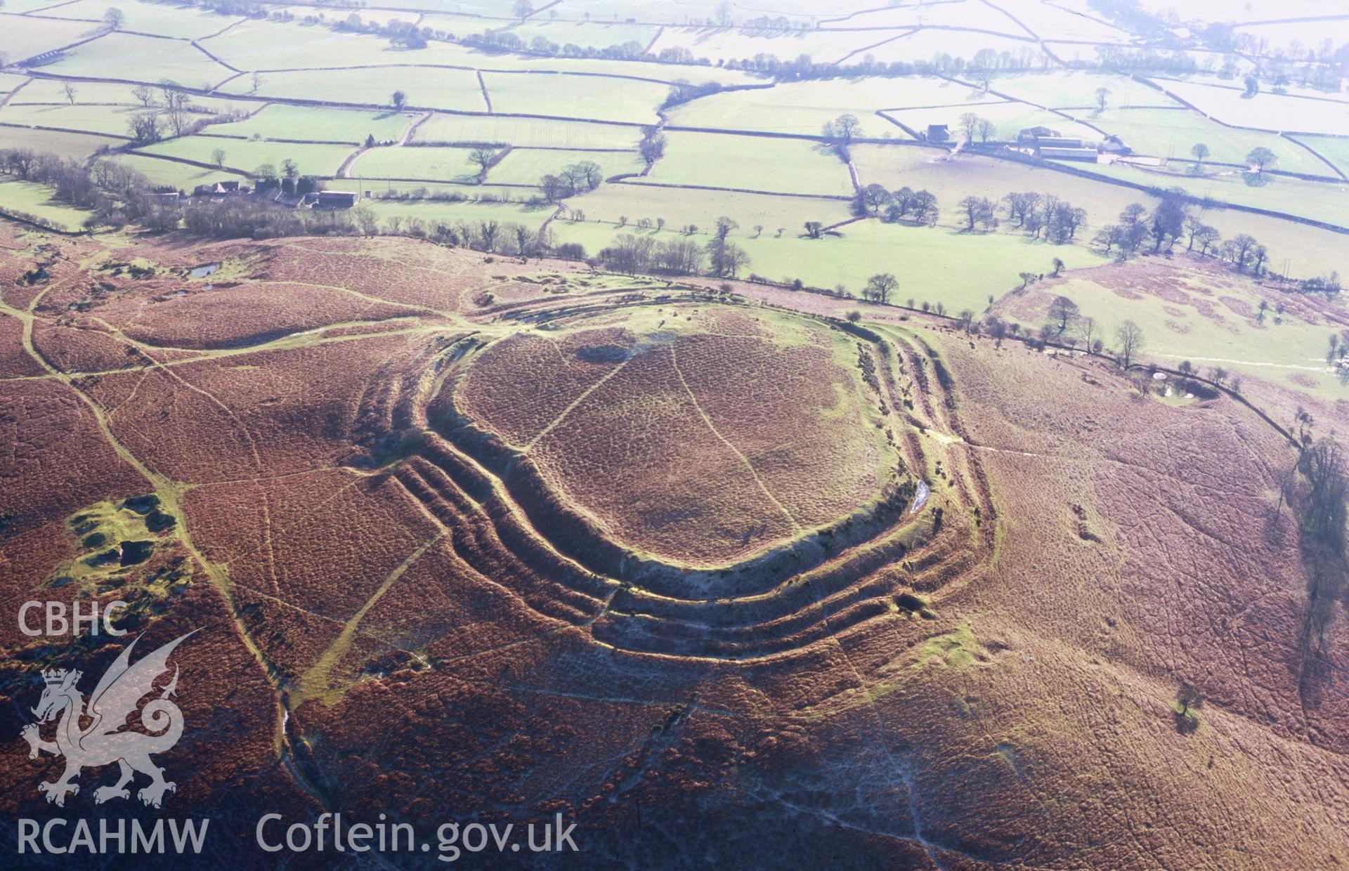 Slide of RCAHMW colour oblique aerial photograph of Pen-y-crug, taken by T.G. Driver, 22/1/1999.