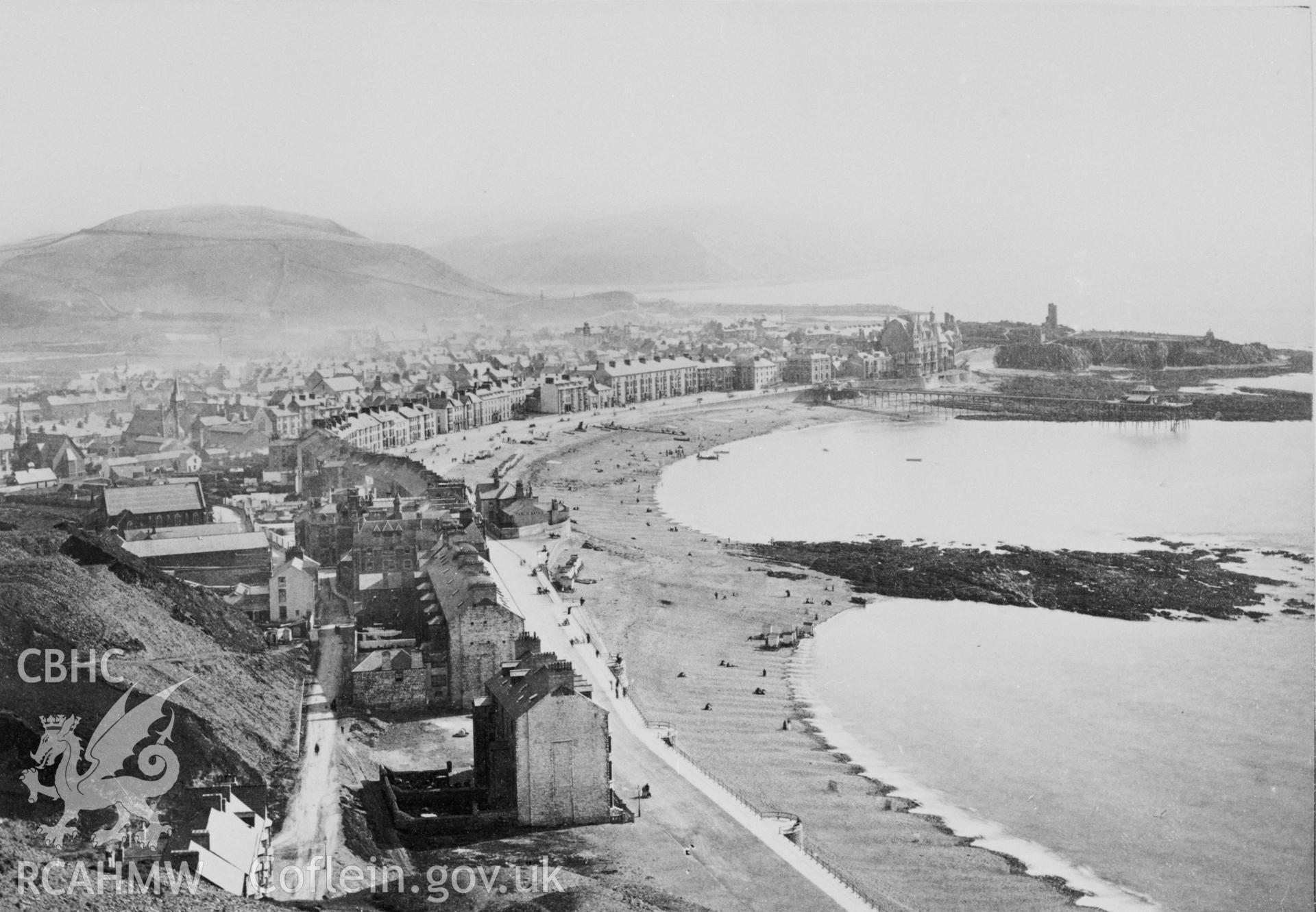Five mounted, black and white photographs showing early views of Aberystwyth, including a view showing North Parade in flood, a view of the castle, a view of the promenade from Constitution Hill and a view of The Queen's Hotel.