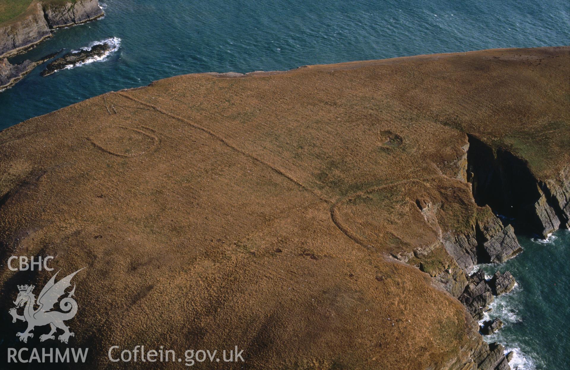 Slide of RCAHMW colour oblique aerial photograph of Cardigan Island, taken by C.R. Musson, 26/7/1989.