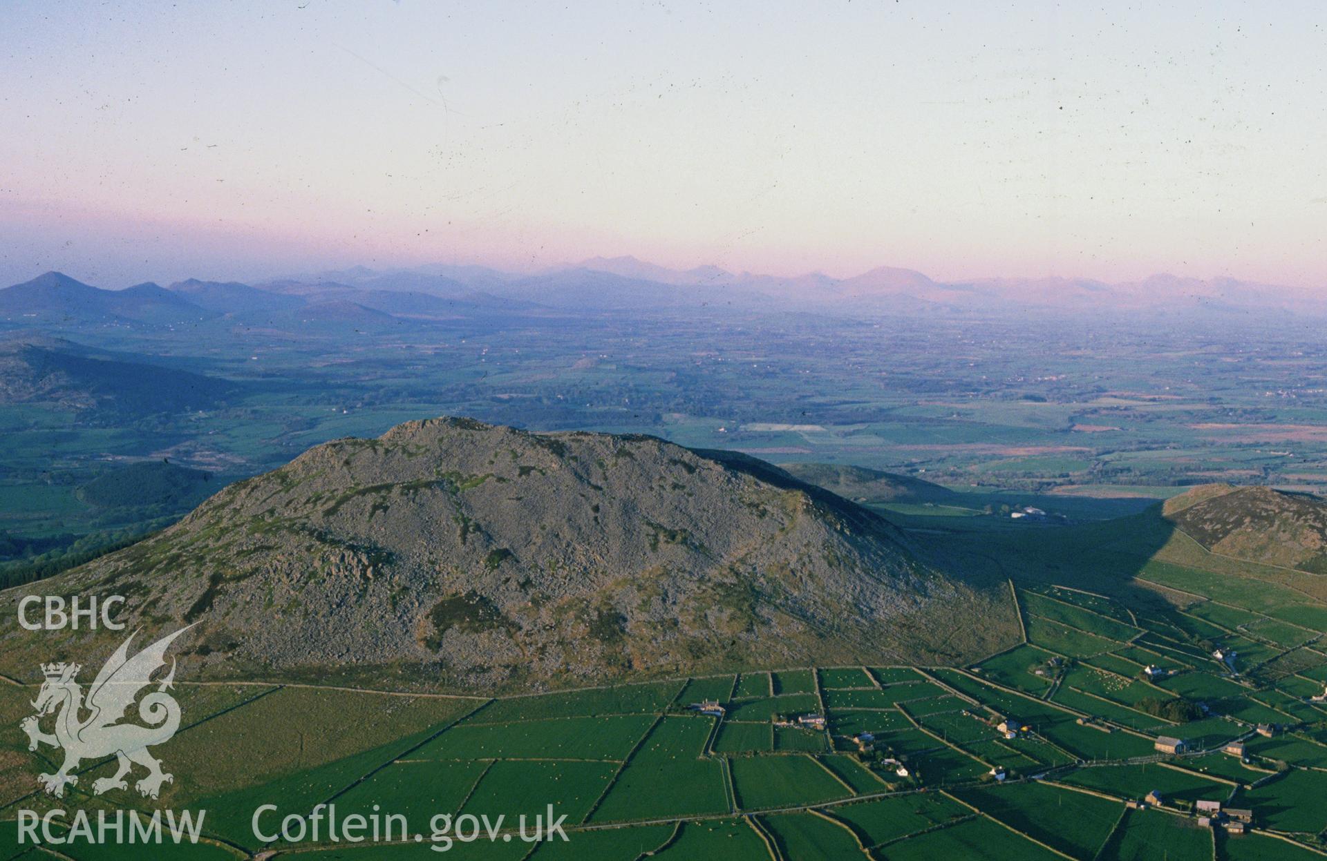 Slide of RCAHMW colour oblique aerial photograph of Hillfort; Carn Fadrun, taken by C.R. Musson, 9/5/1989.
