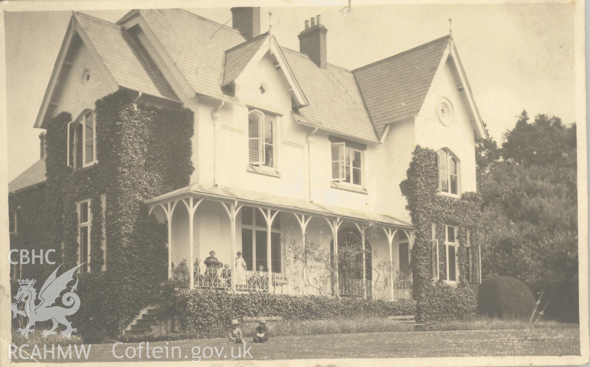 Digitised postcard image of unnamed house in Usk with figures. Produced by Parks and Gardens Data Services, from an original item in the Peter Davis Collection at Parks and Gardens UK. We hold only web-resolution images of this collection, suitable for viewing on screen and for research purposes only. We do not hold the original images, or publication quality scans.