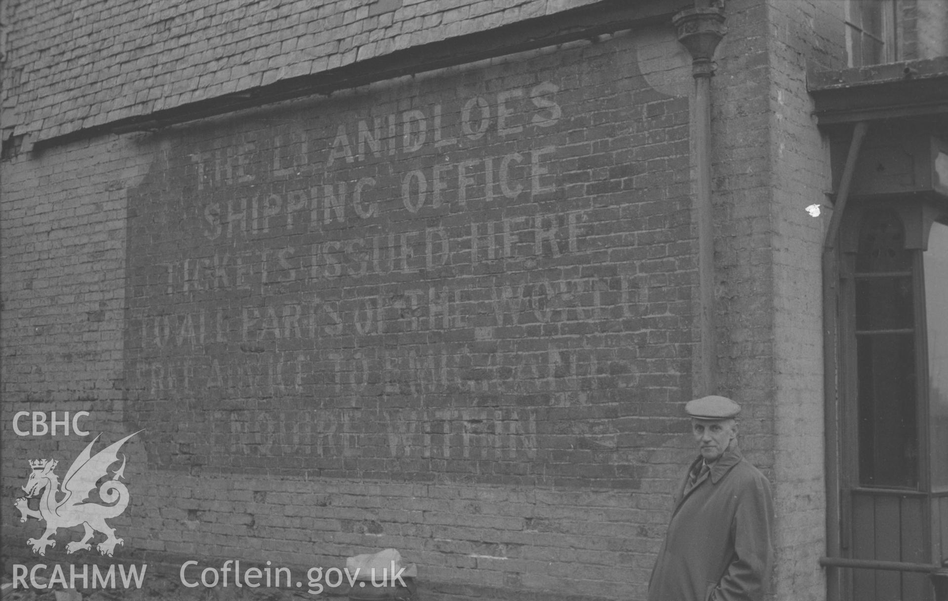 Black and White photograph showing emigration notice outside Llanidloes Shipping Office.