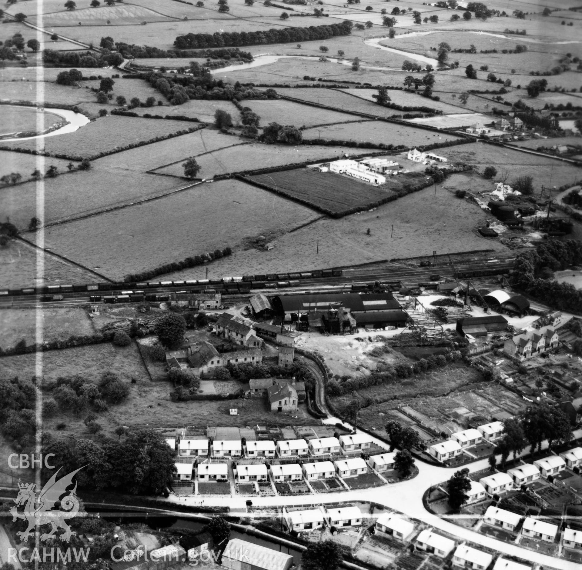 View of Welshpool showing Boys & Boden Ltd., Mill Lane, and prefab bungalows. Oblique aerial photograph, 5?" cut roll film.