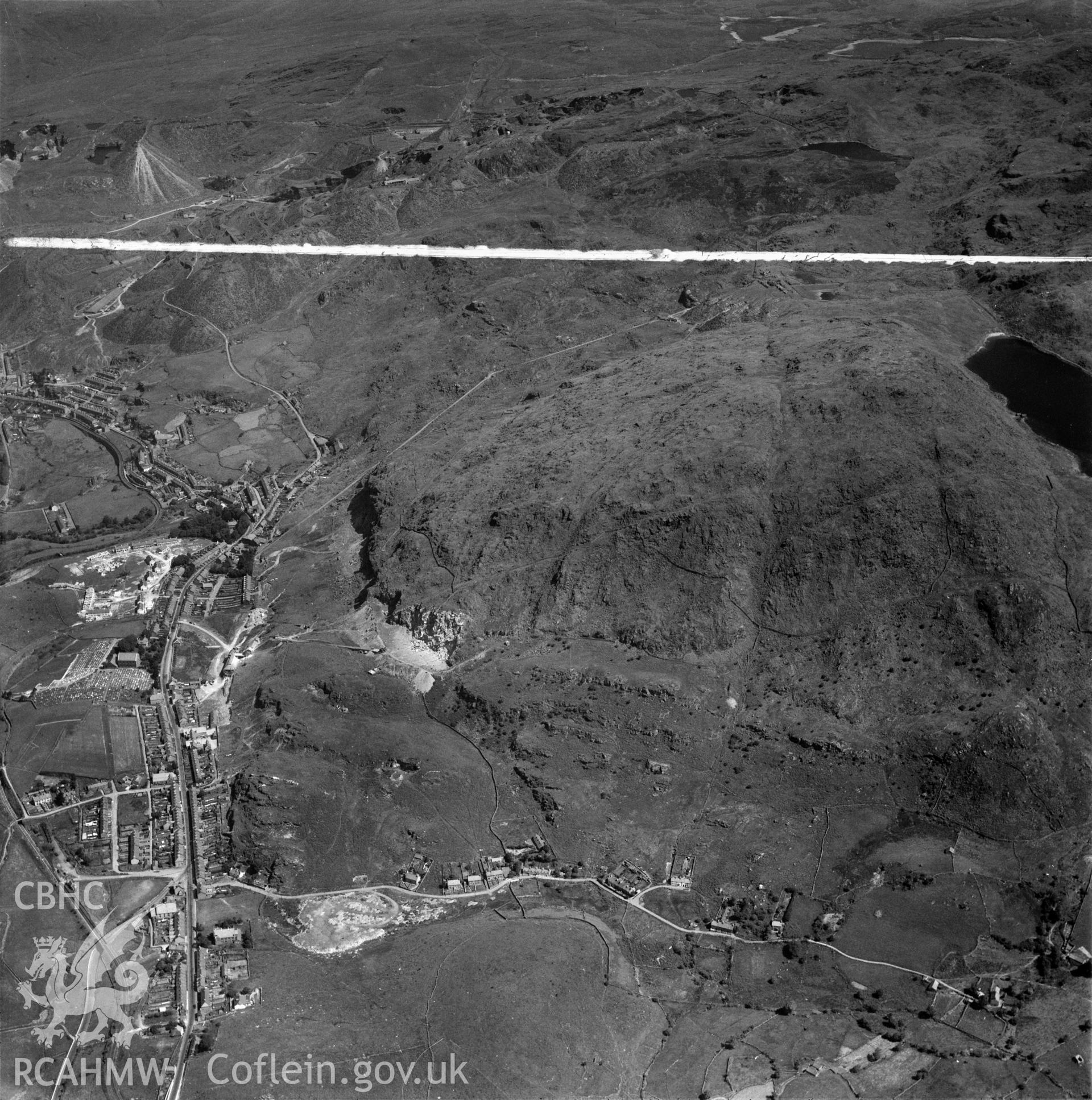 Distant view of Madoc quarry, Blaenau Ffestiniog, commissioned by Cawood Wharton & Co. Ltd.. Oblique aerial photograph, 5?" cut roll film.
