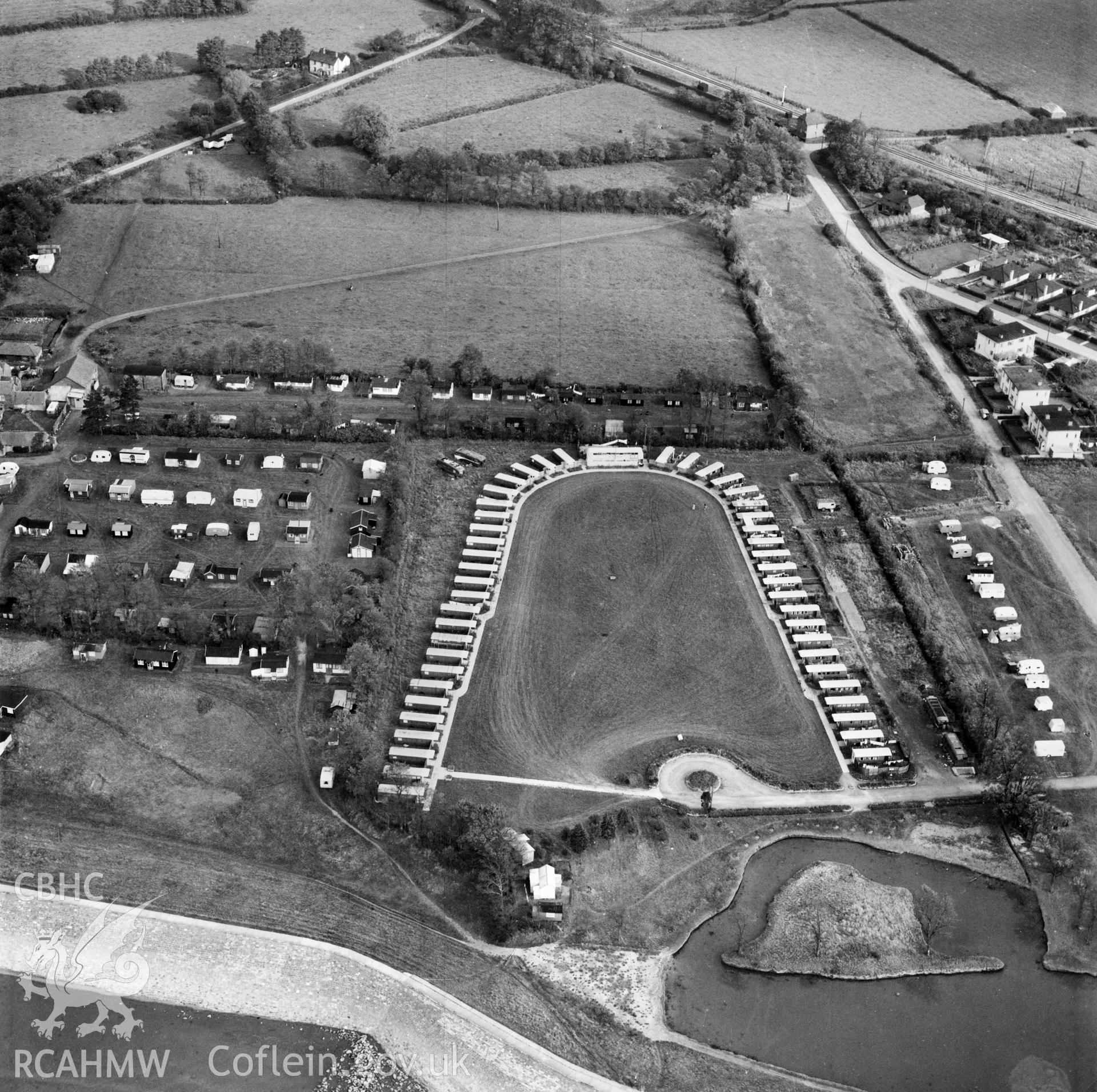 View of horseshoe shaped caravan park and prefabs located near Chepstow. Oblique aerial photograph, 5?" cut roll film.