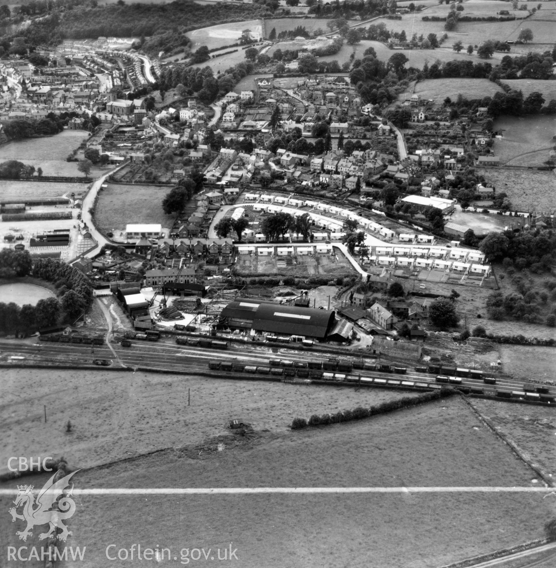View of Welshpool showing Boys & Boden Ltd., Mill Lane, and prefab bungalows. Oblique aerial photograph, 5?" cut roll film.
