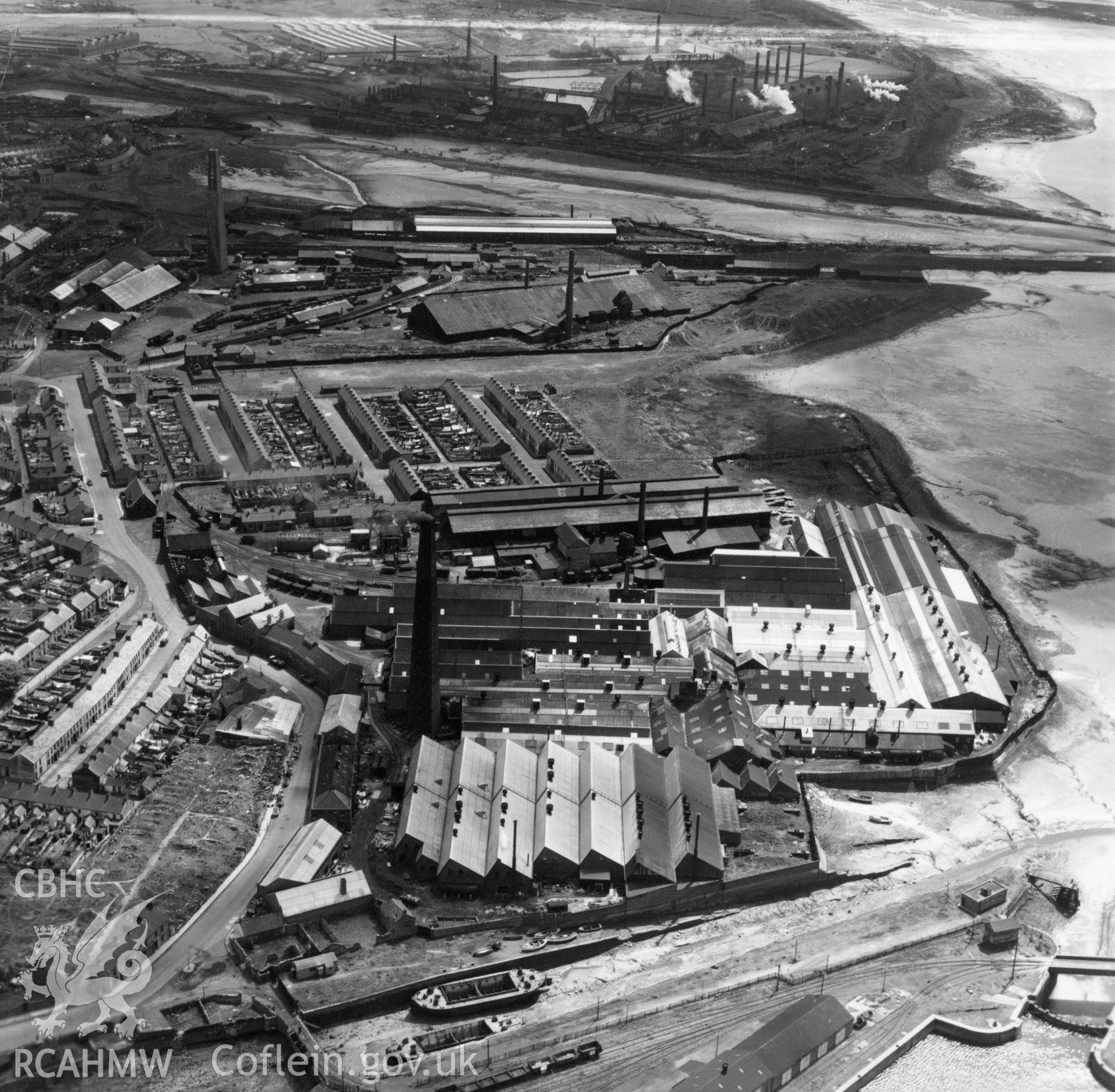 View of the Welsh Tin Plate & Metal Stamping Co. Ltd., Llanelli, showing the South Wales tinplate works in the distance. Oblique aerial photograph, 5?" cut roll film.